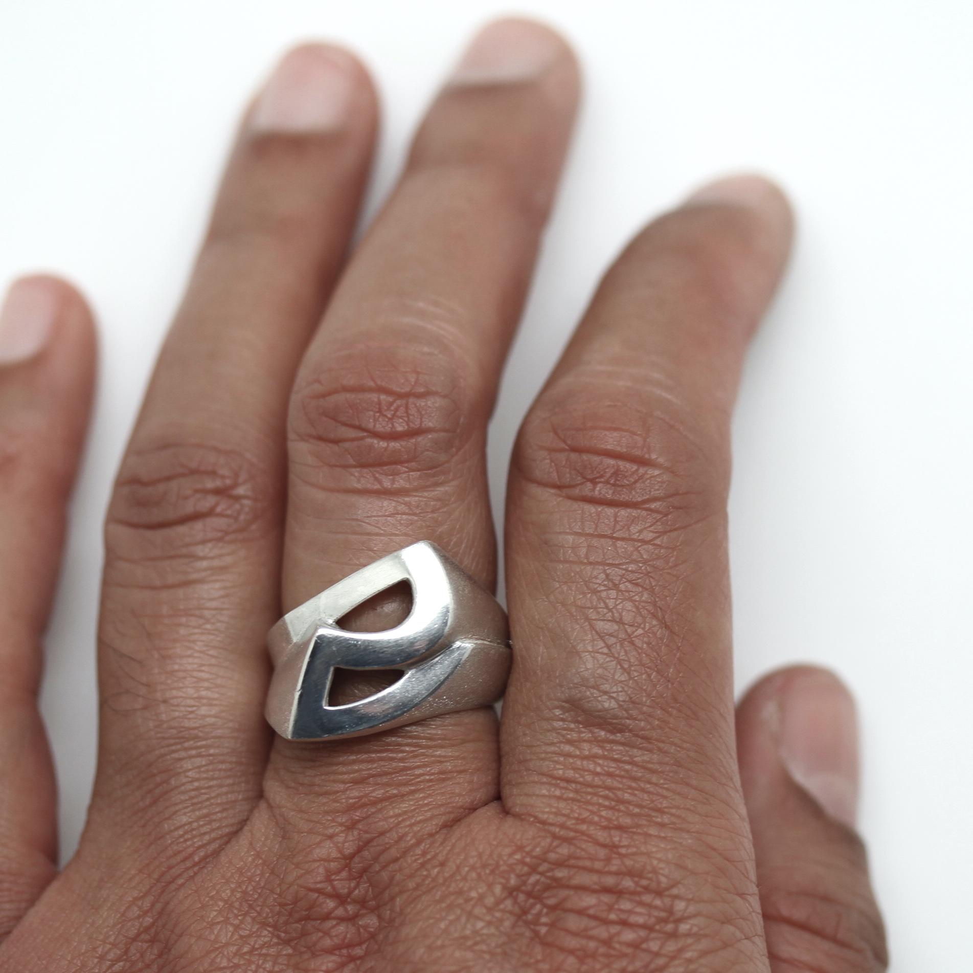 The Protractor symbol gets a sculptural twist in this unisex ring. Sandblasted and polished sterling surfaces contrast like adobe and glass. 

This listing is for a Size 8.  Available to order in sizes 6-10 and in alternative metals. Please inquire