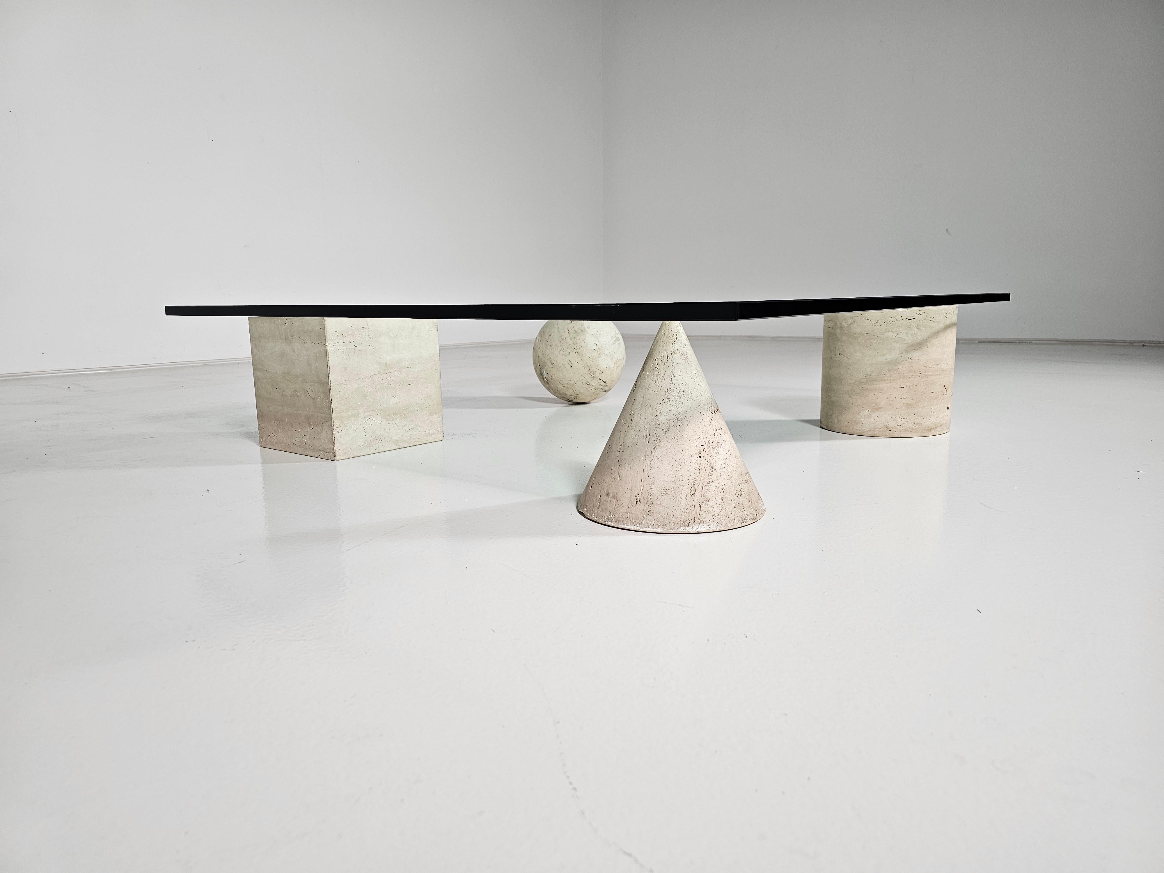 Sculptural Metafora travertine coffee table designed by Lella and Massimo Vignelli. in the 1970s. Inspired by the four forms of Euclidean geometry, the cube, the pyramid, the cylinder, and the sphere, the four elements can be positioned freely for a