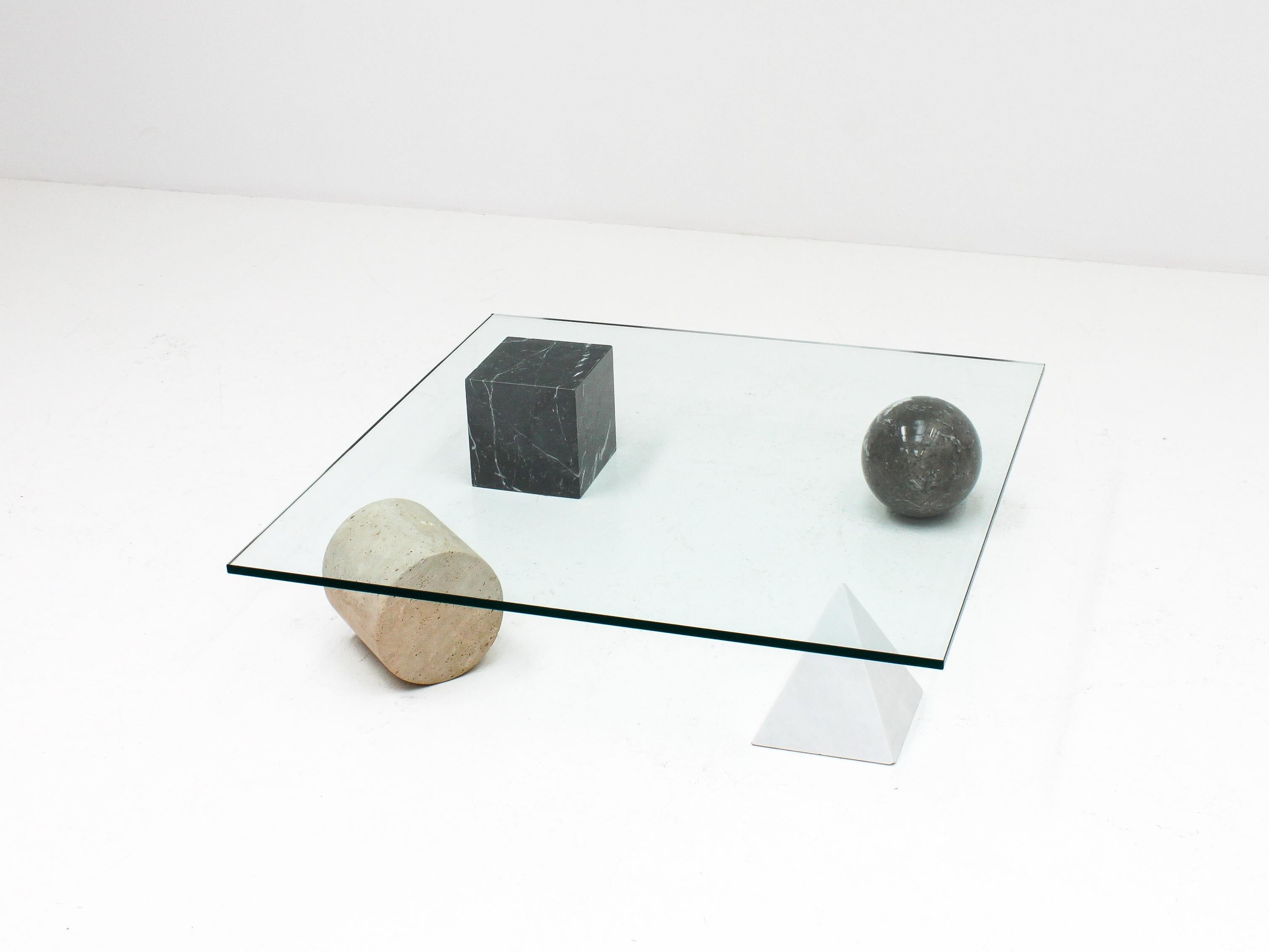 A ‘Metafora’ coffee table by Massimo and Lella Vignelli for Casigliani, Italy. 

Constructed of four geometric marble shapes which form the base including a solid Carrara marble pyramid, travertine cylinder, black marble block and granite sphere and