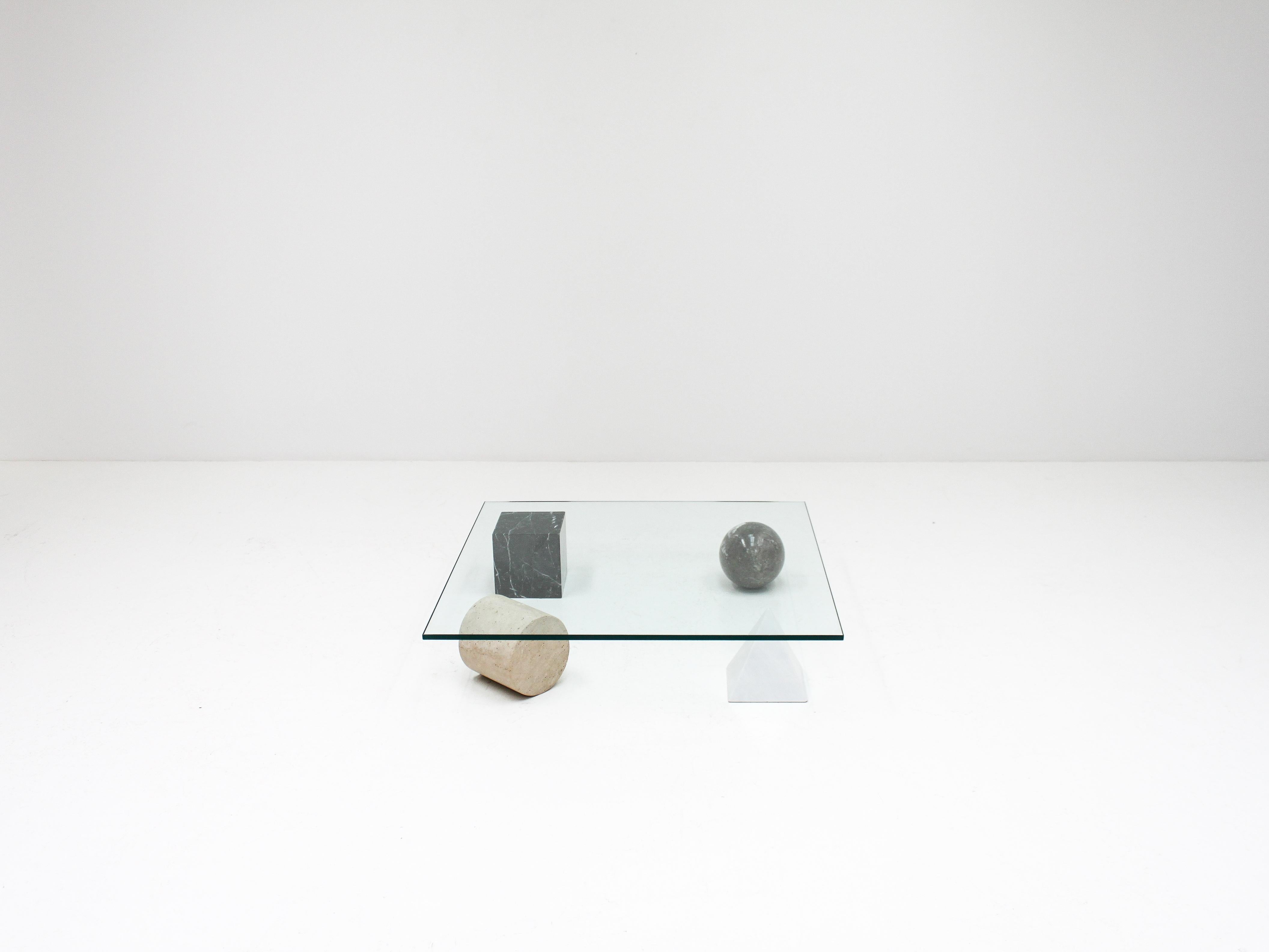 A ‘Metafora’ coffee table by Massimo and Lella Vignelli for Casigliani, Italy. 

Constructed of four geometric marble shapes which form the base including a solid Carrara marble pyramid, travertine cylinder, black marble block and granite sphere