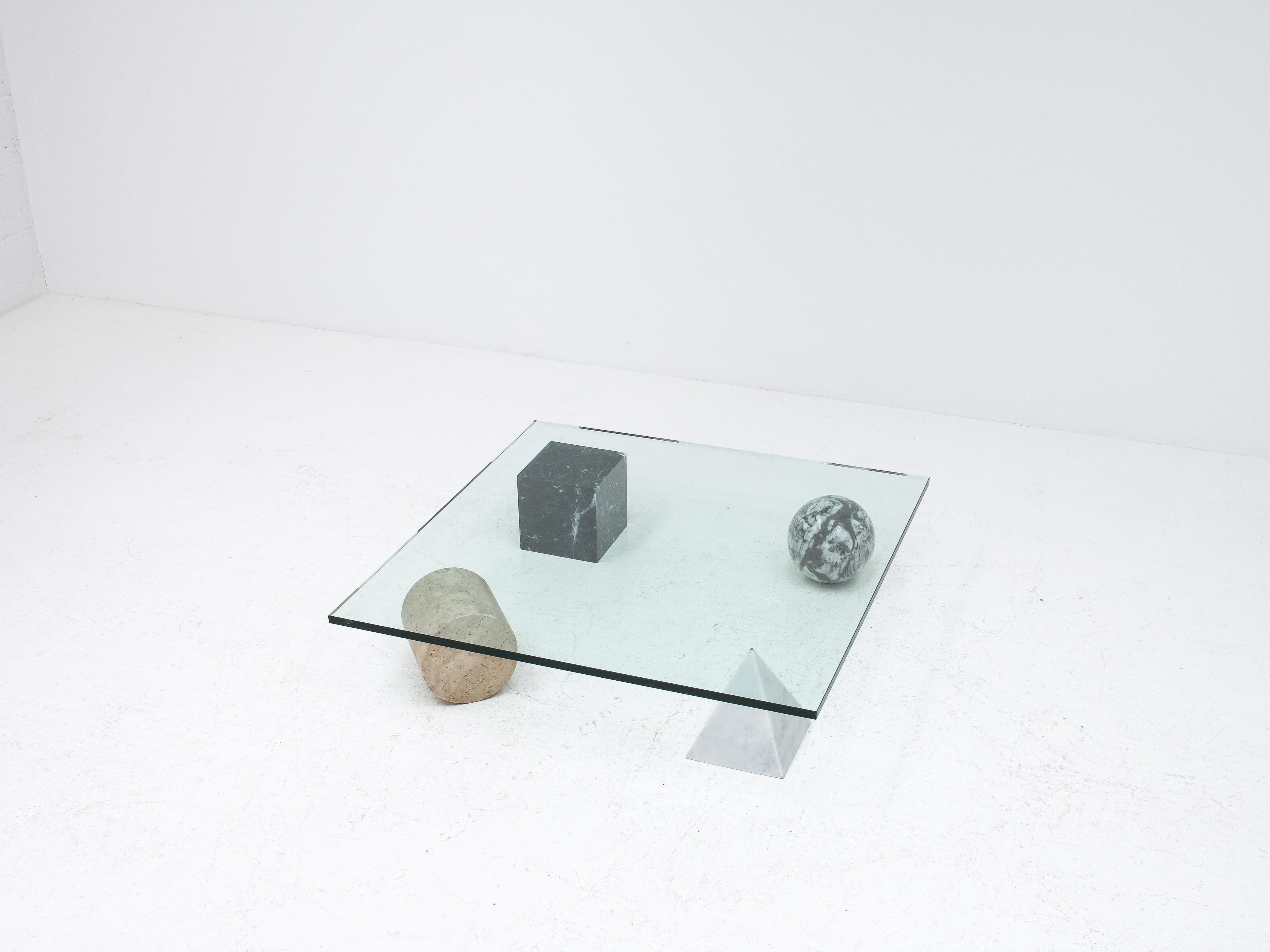 A ‘Metafora’ coffee table by Massimo and Lella Vignelli for Casigliani, Italy, 1979. 

Constructed of four geometric marble shapes which form the base including a solid Carrara marble pyramid, travertine cylinder, black marble block and granite