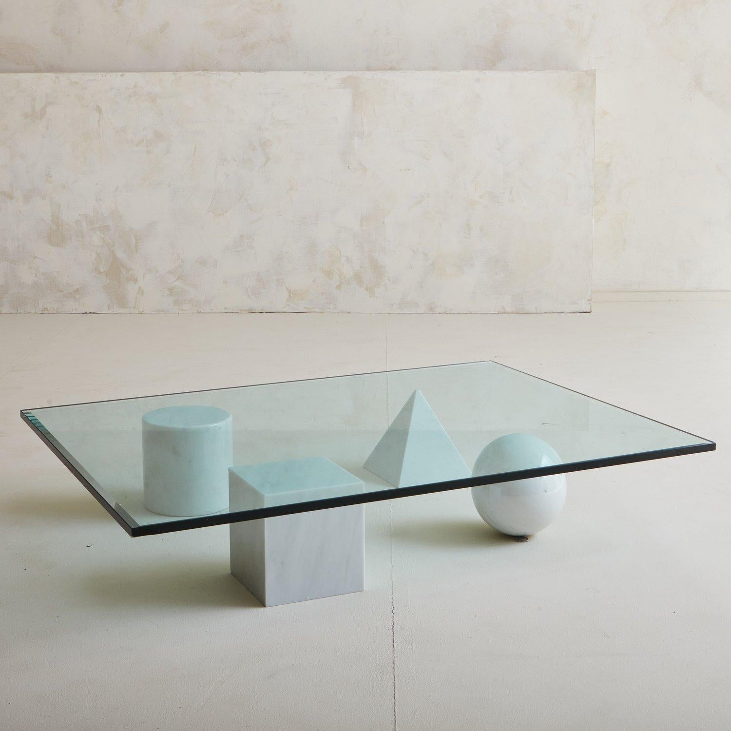 A Massimo Vignelli & Lella Vignell Metafora coffee table featuring four geometric shapes in Carrara marble and a rectangular .75” thick glass top. Italy, 1970s.

Massimo Vignelli (January 10, 1931 – May 27, 2014) was an Italian designer who worked