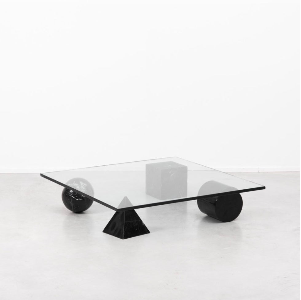 A stunning and sculptural Metafora coffee table designed by Lella and Massimo Vignelli.  Inspired by the four forms of Euclidean geometery, the cube, the pyramid, the cylinder and the sphere are made from black Marquinia marble topped by a thickened