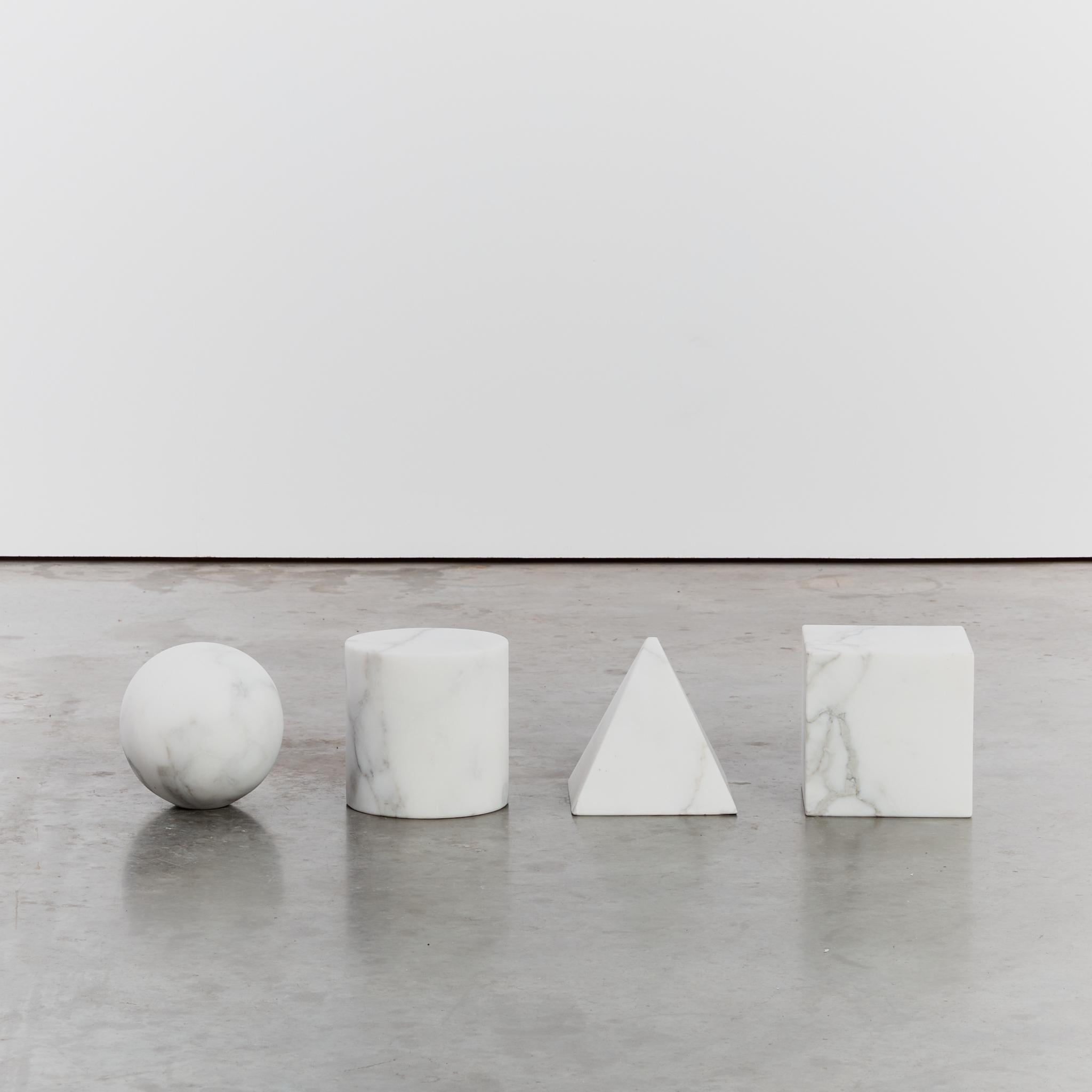 'Metafora' table by Lella and Massimo Vignelli in white marble.

Made in Italy in the late 1970s and inspired by the four forms of Euclidean geometry: the cube, the pyramid, the cylinder and the sphere. These forms are made out of black marble and