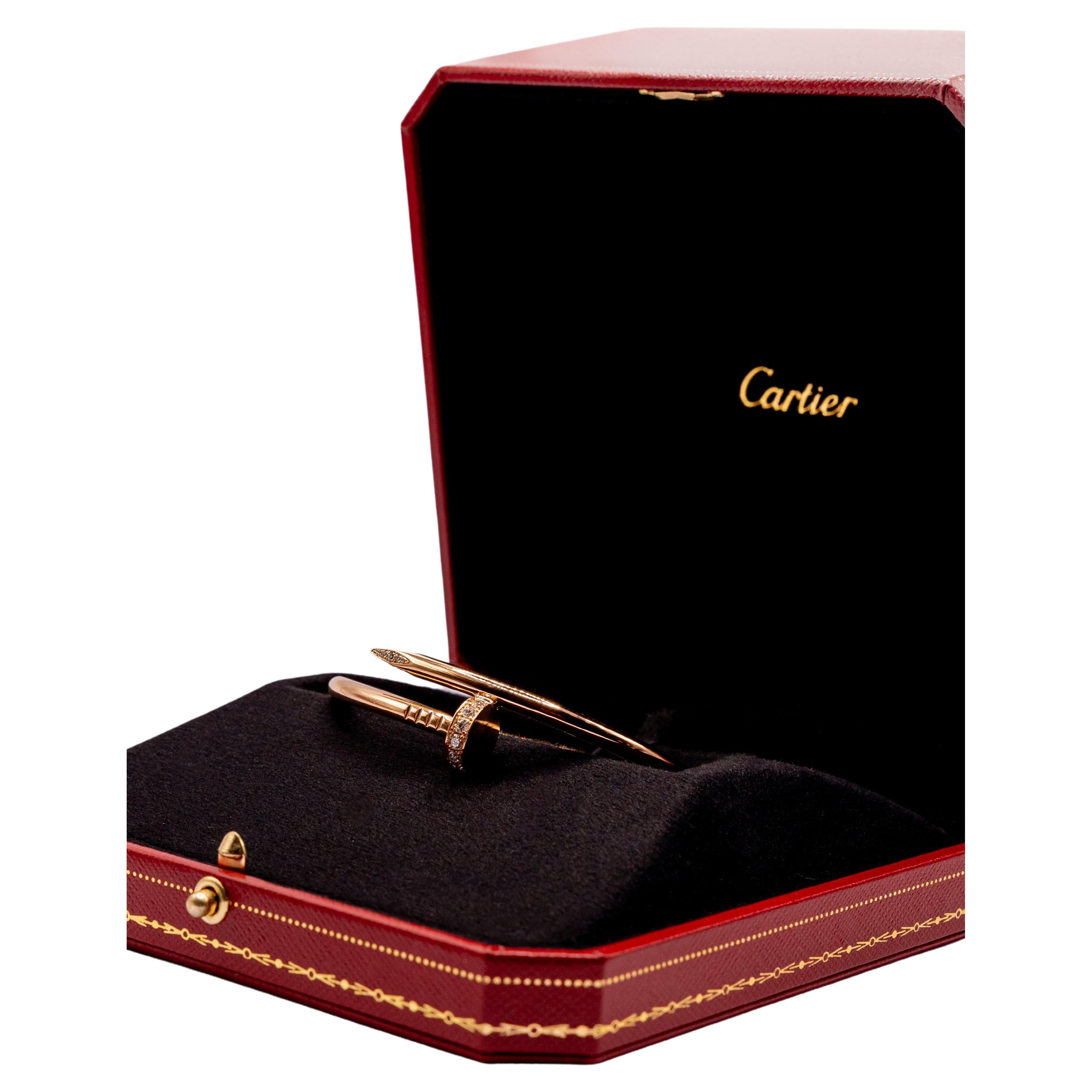 The iconic zippered bangle bracelet Juste un Clou by luxury jeweler Cartier is simply stunning. This elegant bypass bracelet features a subtle curved nail pattern in shiny rose gold. The head and tip of the nail are embellished with sparkling pavé