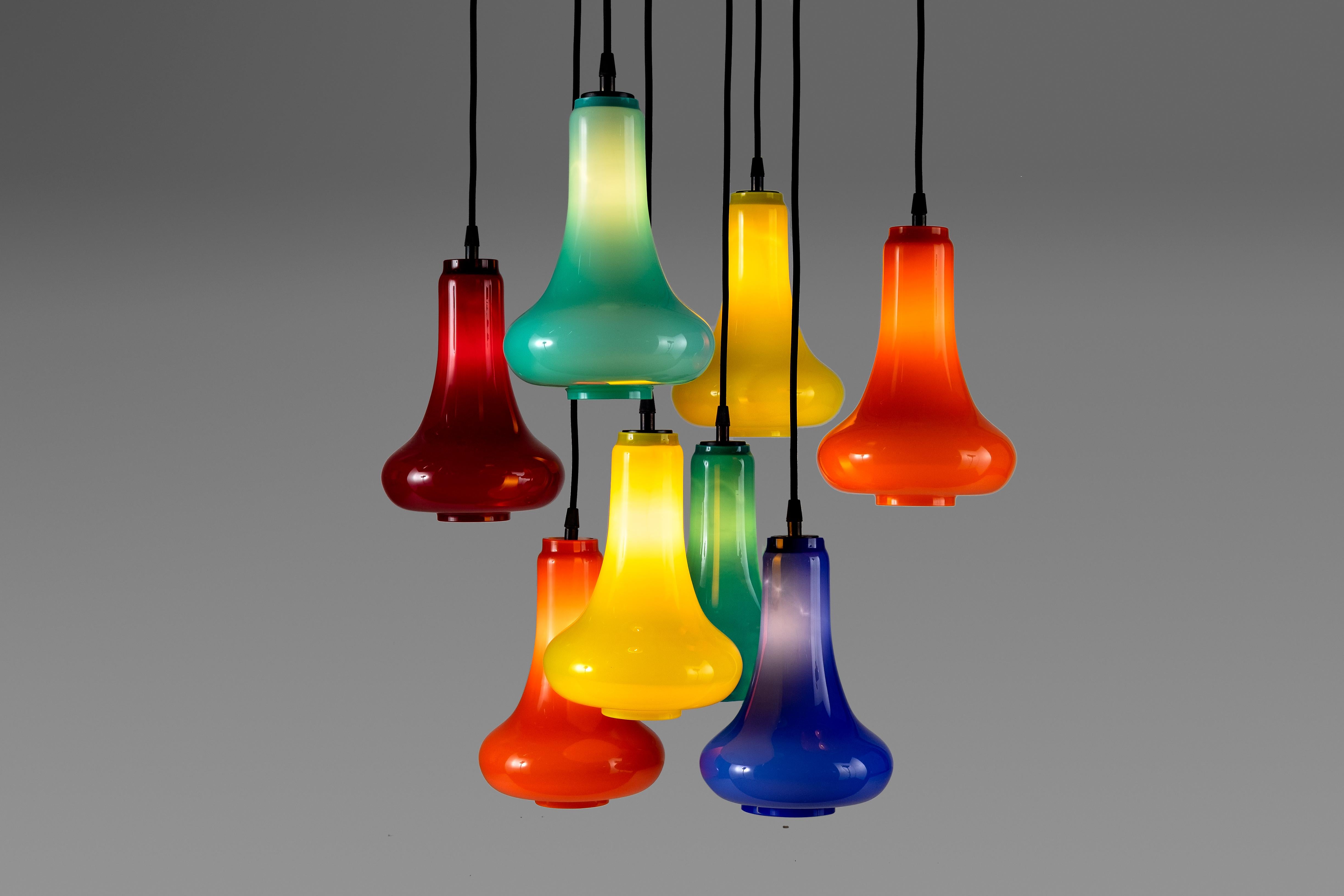 This chandelier is a decorative invention made out of colored Murano glasses: the aim of the unknown designer is clearly to focus the attention on the color, leaving the structure a secondary role. The glass shape, with its slimmer top part