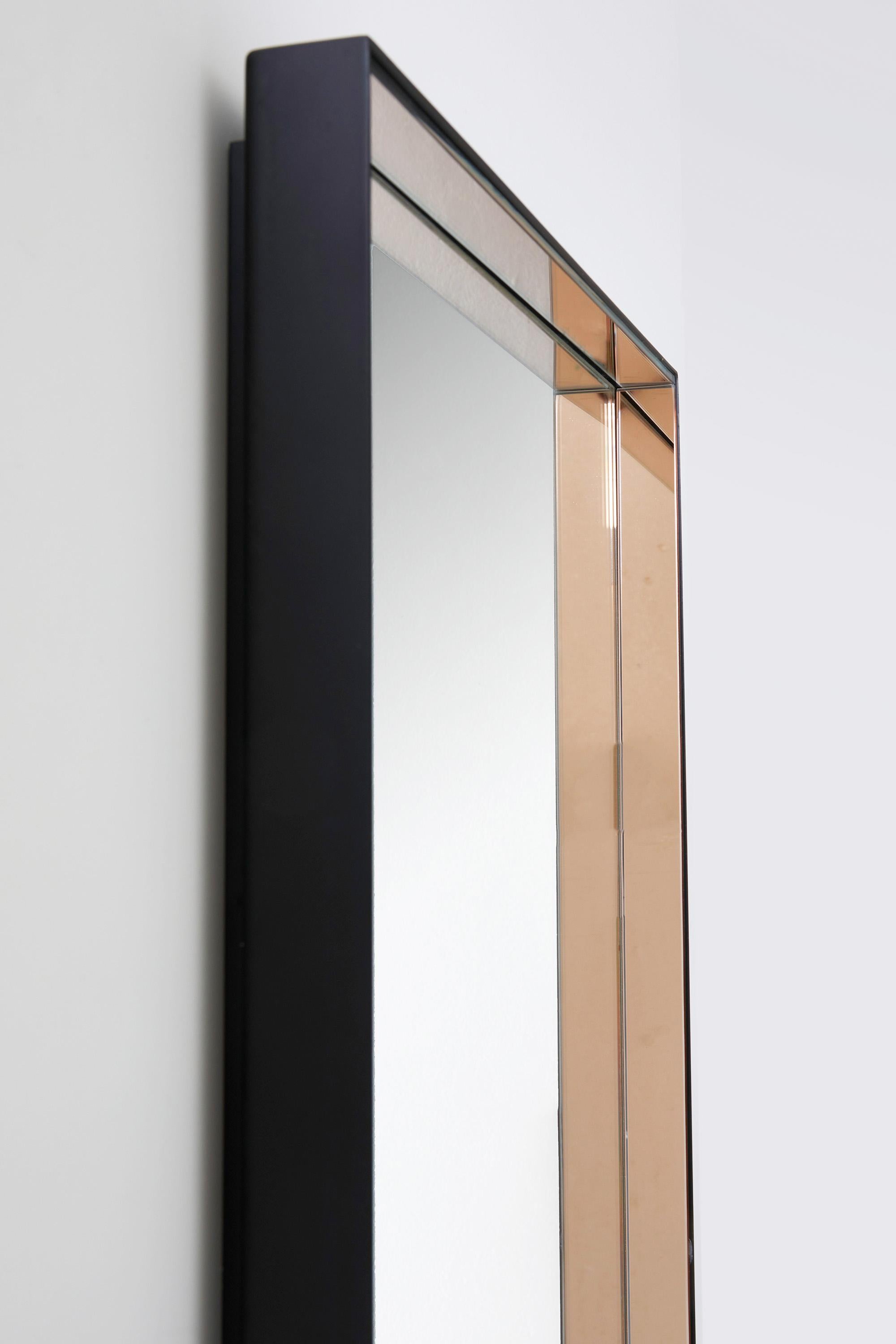Rectangular mirror model N°1929 by Fontana Arte, Italy 1962

Attributed to Max Ingrand, this elegant wall mirror is composed of a thin black lacquered metal frame which hosts thick strips of colored glass.

This mirror exemplifies the minimalist