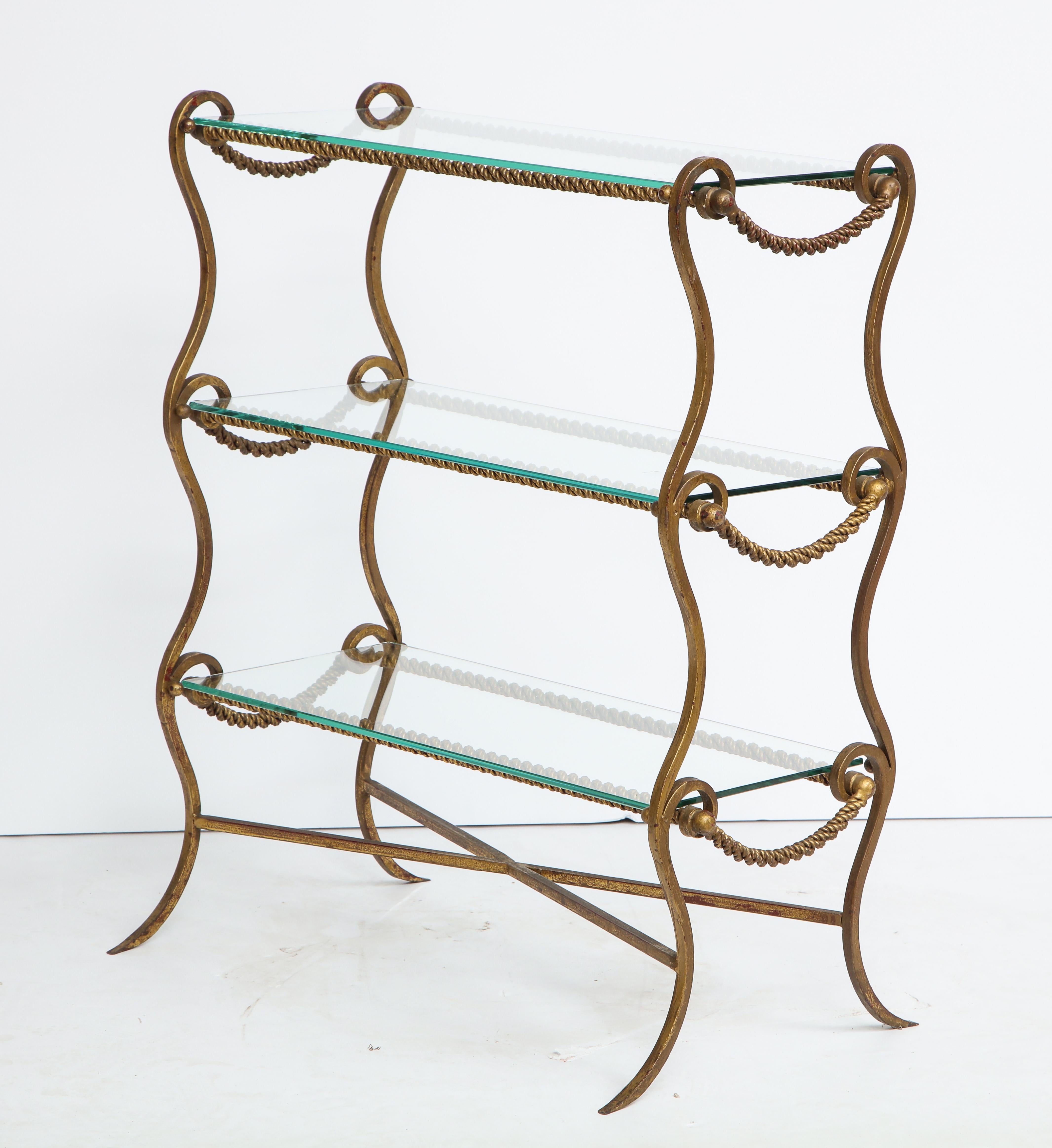 Metal end table with twisted rope design and three glass shelves 