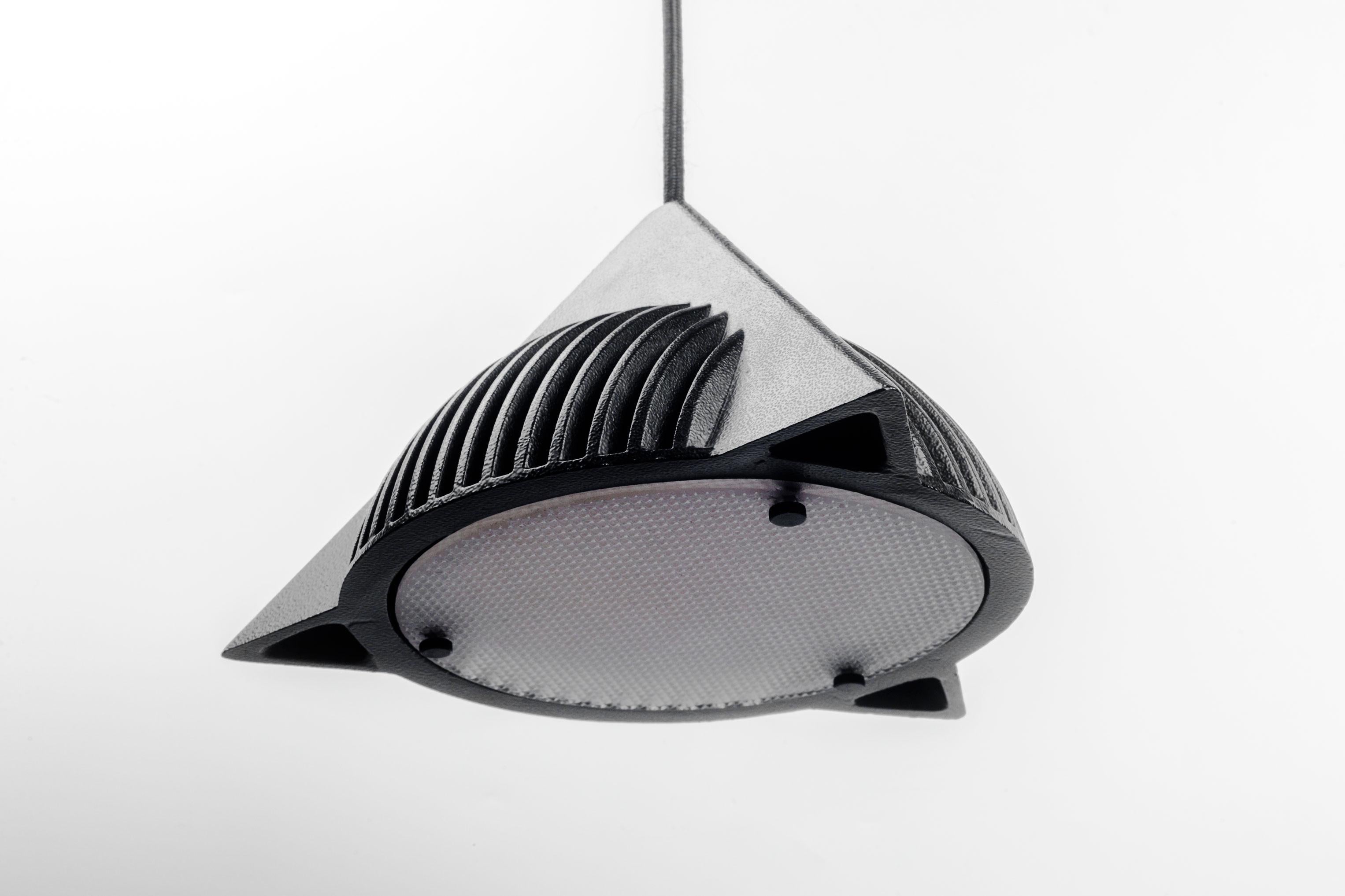 Schwarze Metallpyramide mit Glasdiffusor, entworfen von Ron Rezek in den 1990er Jahren. Eine gusseiserne Halbkugel im Inneren einer Pyramide, die wie ein UFO schwebt. Geometrische Grundformen werden in einem postmodernen Stil kombiniert, der wie