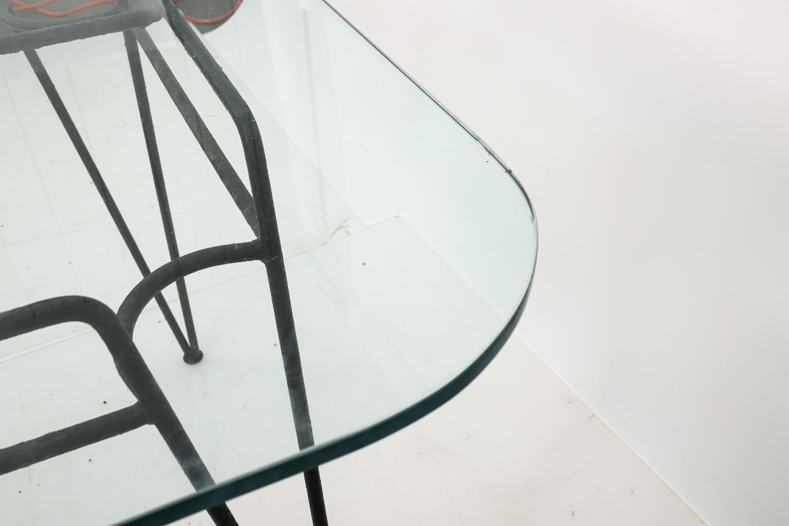 Glass top garden or outdoor dining table by Russell Woodard in the style of Sculptura with metal base. Please note of wear consistent with age.