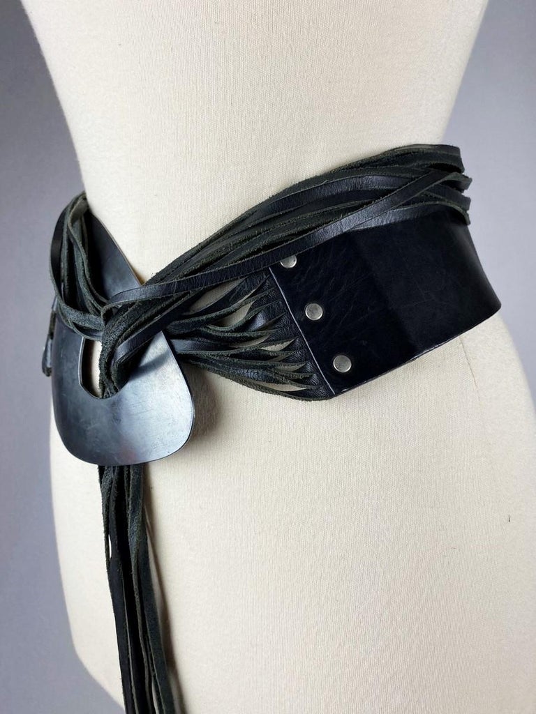 Circa 1990

France

Black leather belt with straps and brushed metal belt by Jean-Paul Gaultier dating from the 1990s. Fetish and sado-masochistic universe notably by the multiple possibilities offered. Wide black leather belt riveted on a curved