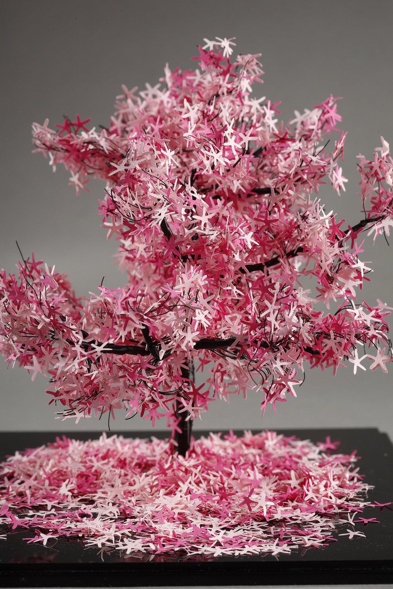 This unique piece by Lebanese artist Nayla Tabet is a tree sculpture combining high-quality metal wires and finely cut pink paper, giving birth to a one-of-a-kind work. The artist likes to explore the contrast between the strength of metal and the