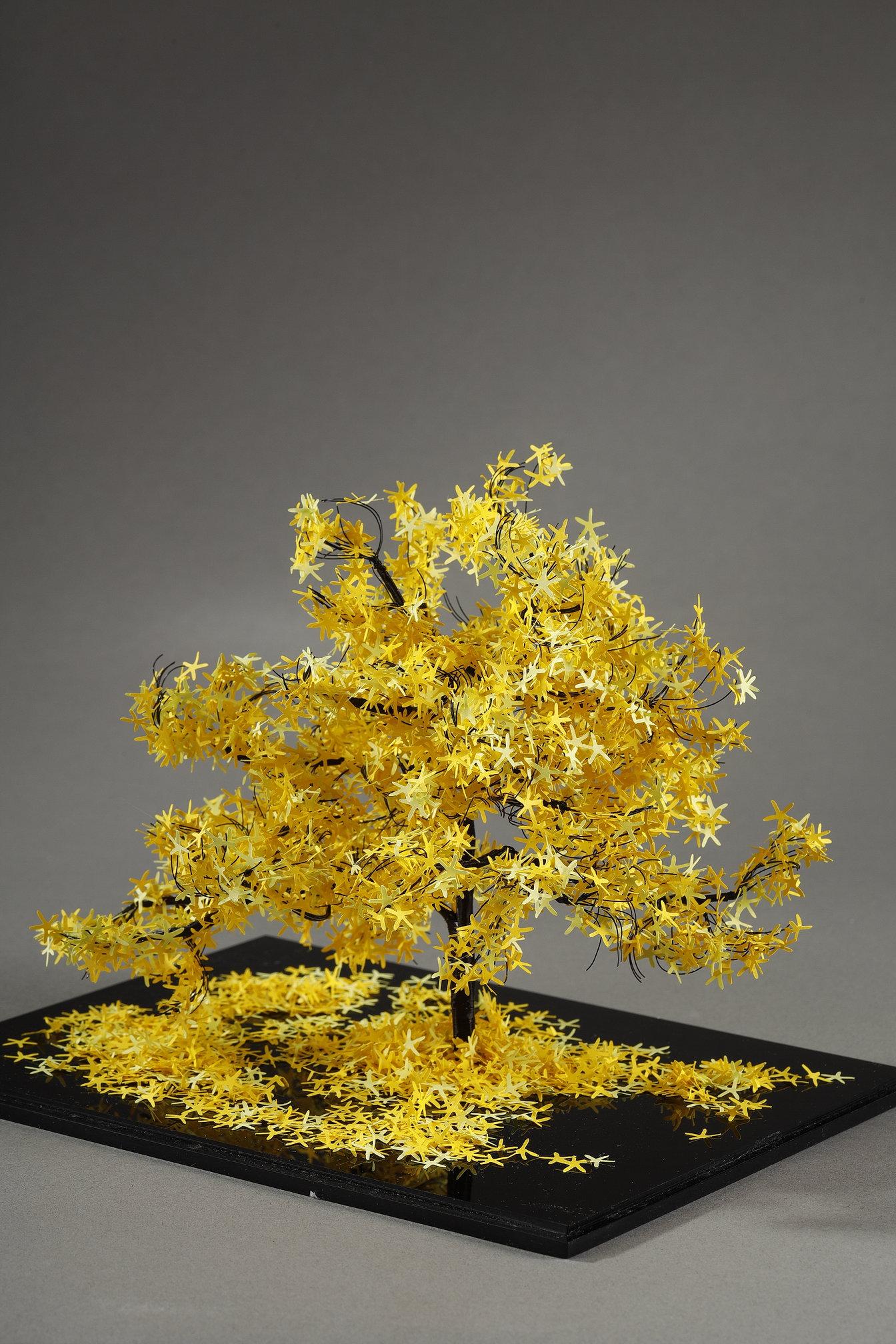 This unique piece by Lebanese artist Nayla Tabet is a tree sculpture combining high-quality metal wires and finely cut yellow paper, resulting in a one-of-a-kind work of art. The artist likes to explore the contrast between the robustness of metal