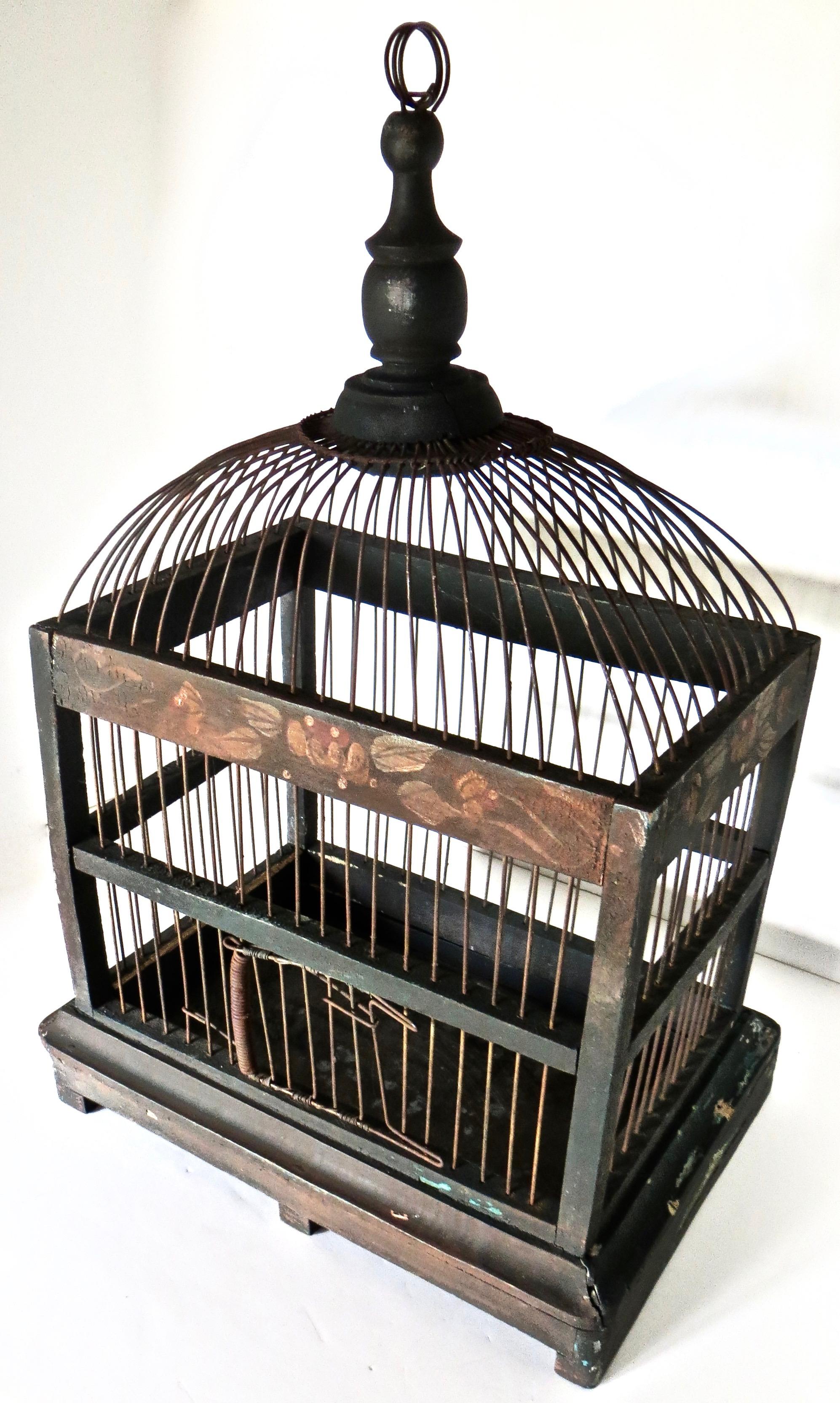 Hand made Folk Art American wire metal and painted wood birdcage, probably from Pennsylvania circa 1905. Having a rectangular body with a dome top; suitable for hanging, or surface decorative presentation, this birdcage is functional albeit it lacks