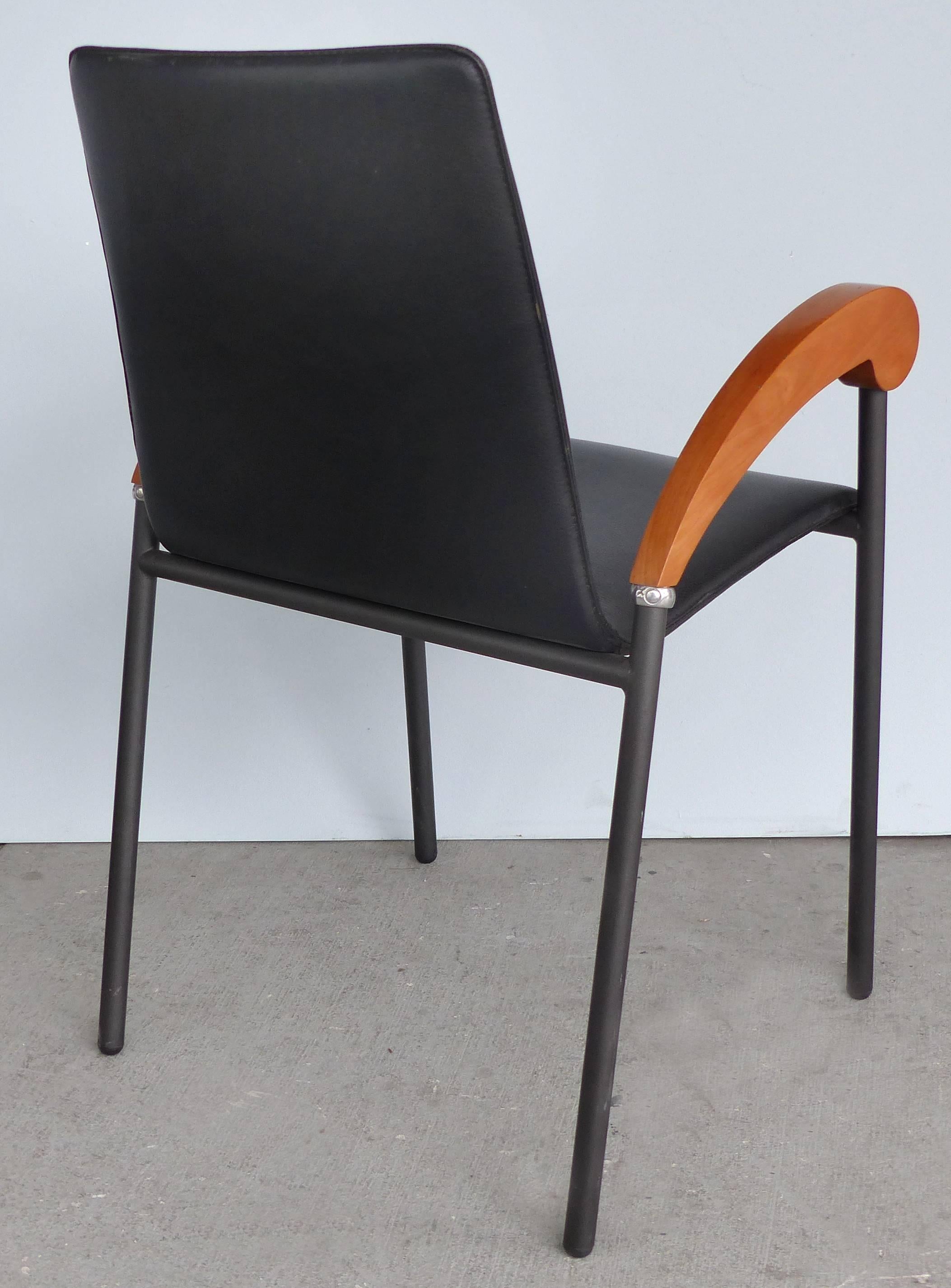 XO Design Metal and Wood Armchairs with Full Grain Leather Seats 

Offered for sale is a set of four modern armchairs marked XO at each curved lacquered wood arm. We attribute the design of these chairs to Phillipe Starck as the frames are so