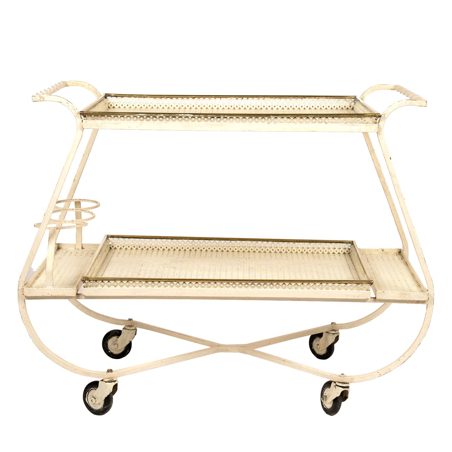 This stylish wrought iron bar cart with perforated quatrefoil mesh removable trays are adorned with polished brass. The cart is in its original French vanilla finish.
My suggestion is to either keep it in its original finish or paint it in the