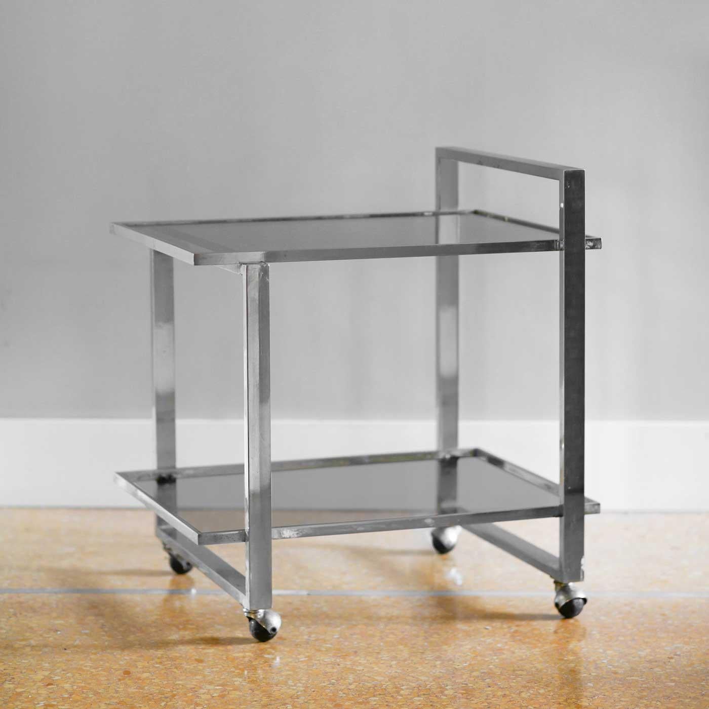 Metal bar trolley with smoked glass shelves.
Product details
Dimensions: 71 W x 77 H x 60 D cm
Materials: metal, smoked glass
Production: Italian manufacture 1970.