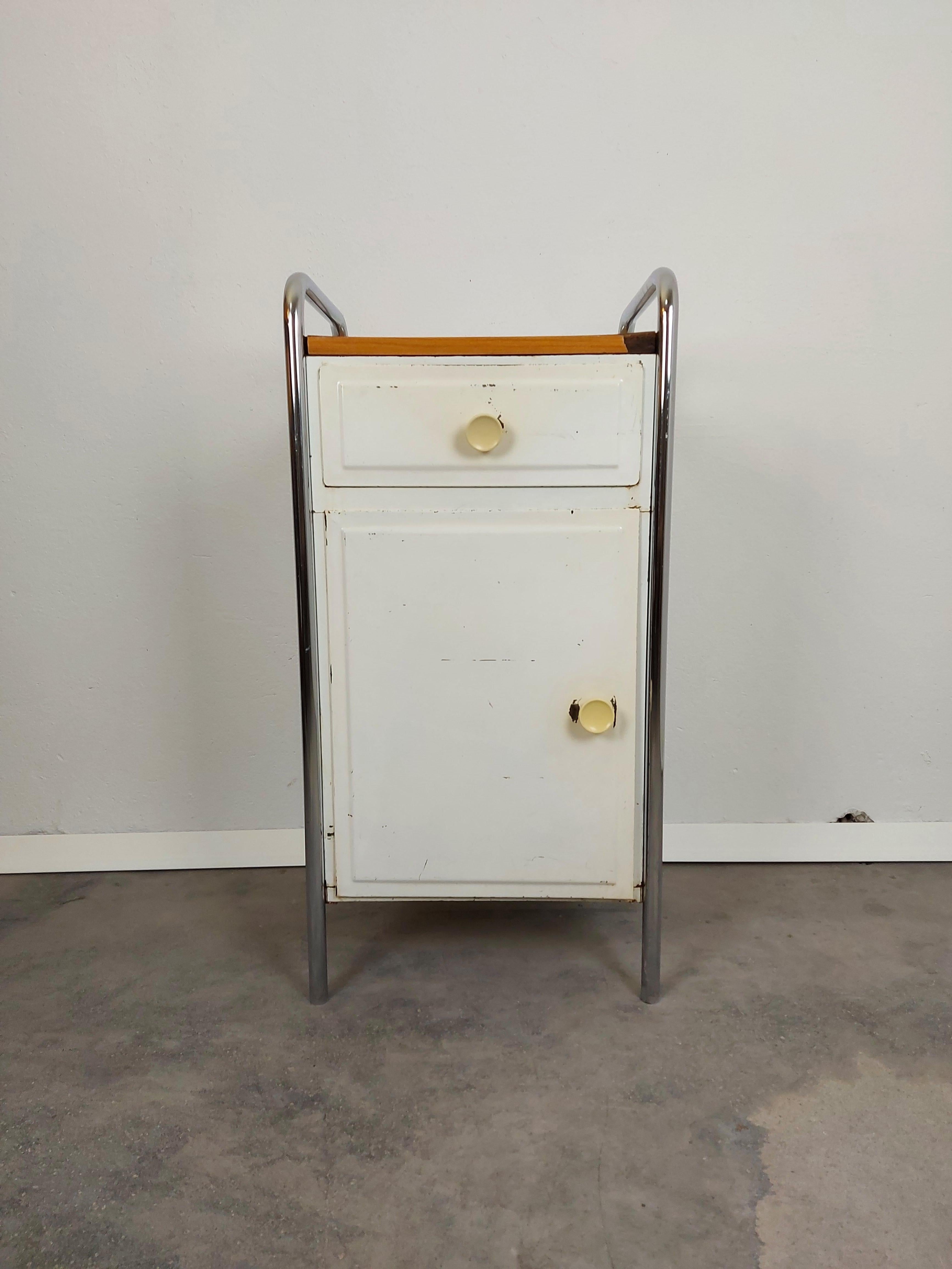 Vintage cabinet with 1 drawer and additional storage space with one shelve.

Material: Metal, Chrome, Plywood

Period: 1970s

Detailed condition: good original vintage condition, few traces of use

Measures: H-78, W-42, D-35.