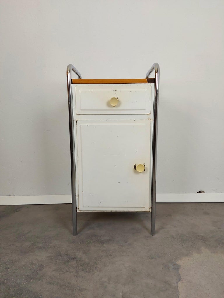 Vintage cabinet with 1 drawer and additional storage space with one shelve.

Material: Metal, Chrome, Plywood

Period: 1970s

Detailed condition: good original vintage condition, few traces of use

Measures: H-78, W-42, D-35.