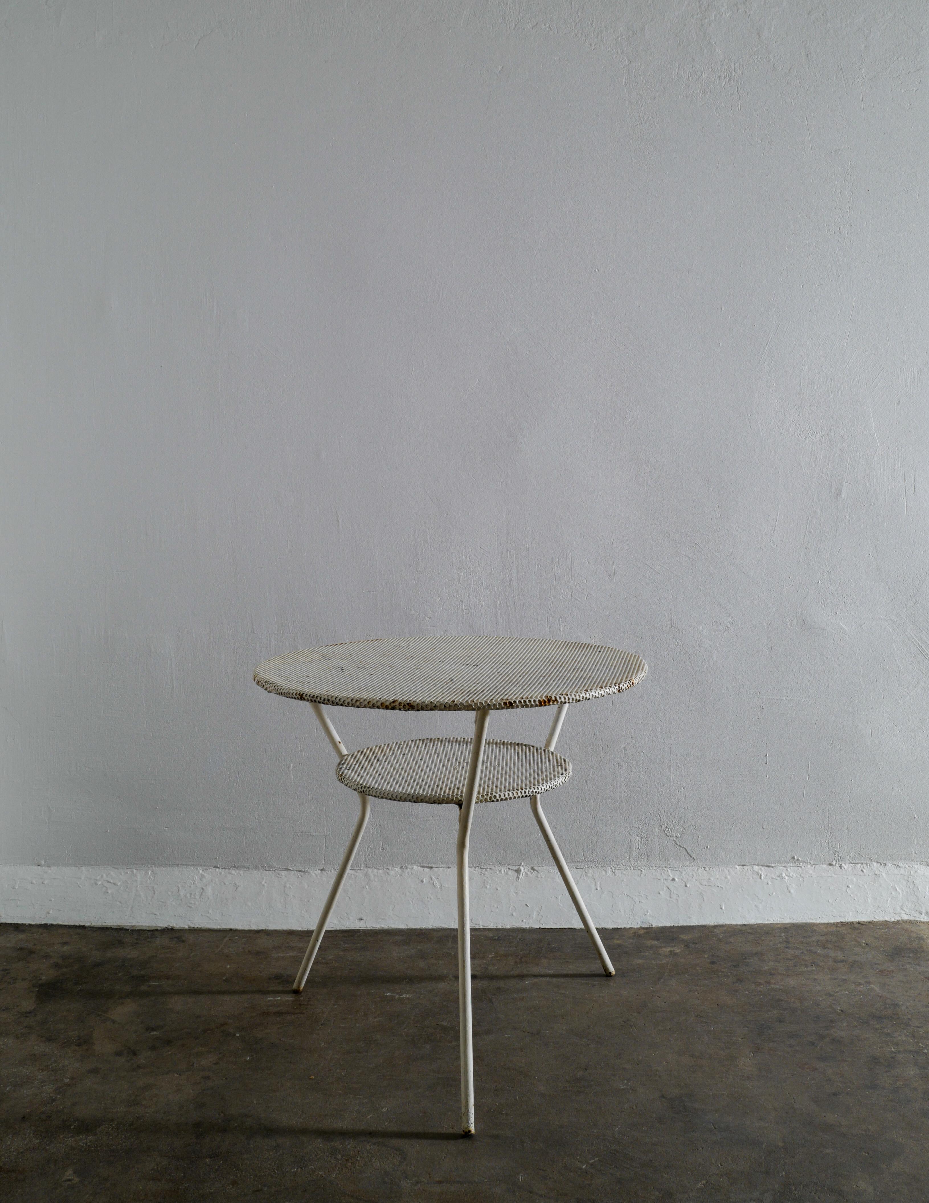 Rare café and side table in style of Mathieu Matégot produced in France during the 1950s. In good vintage condition and showing beautiful patina from age and use. Stable and good to use. Perfect for your garden or home.