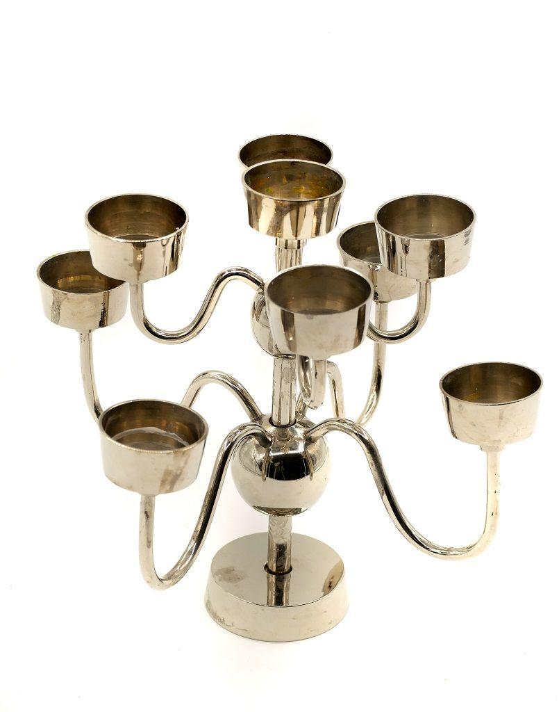 This metal candleholder is an elegant decorative lamp realized in the mid-20th century.

It is a candleholder for 9 lamps entirely made in metal.

Dimensions: cm 22.5 x 26.5 x 26.5.

In excellent conditions.