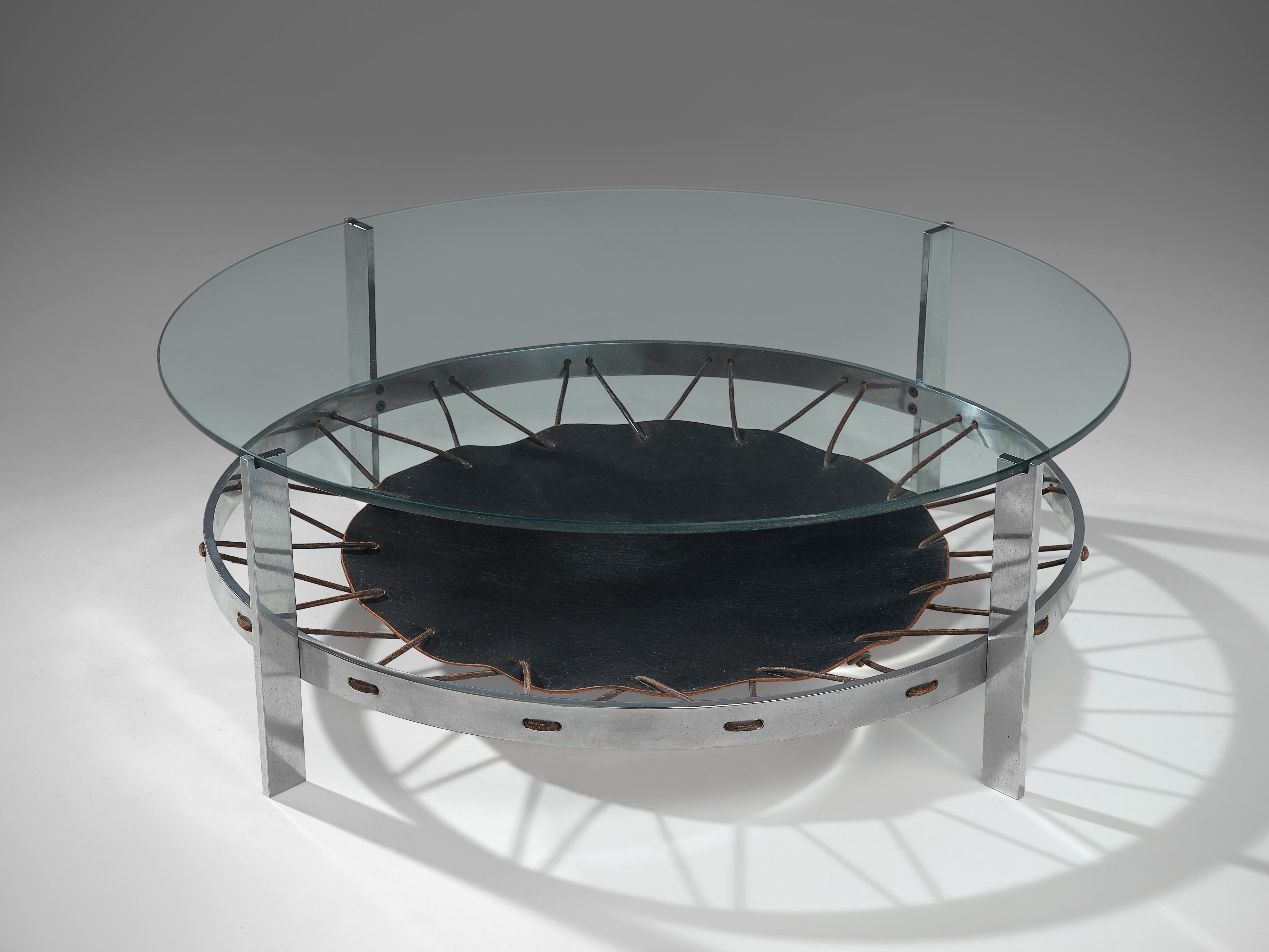 Coffee table, leather, glass and steel, the Netherlands, 1970s

Round coffee table with a superb combination of materials. The chrome base and glass top are very strand materials on itself, but in combination with the black leather the appearance of