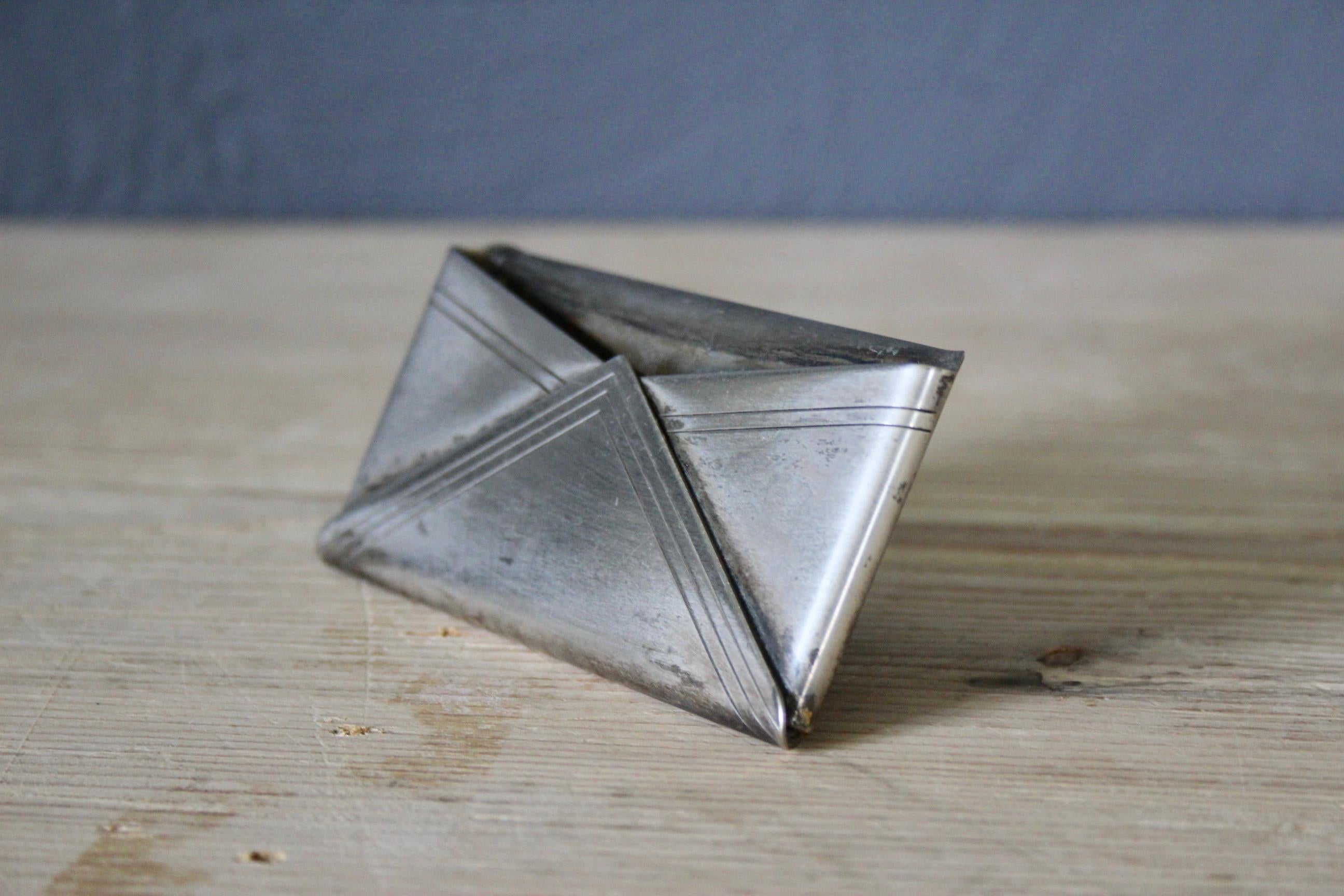 Small metal desk object.