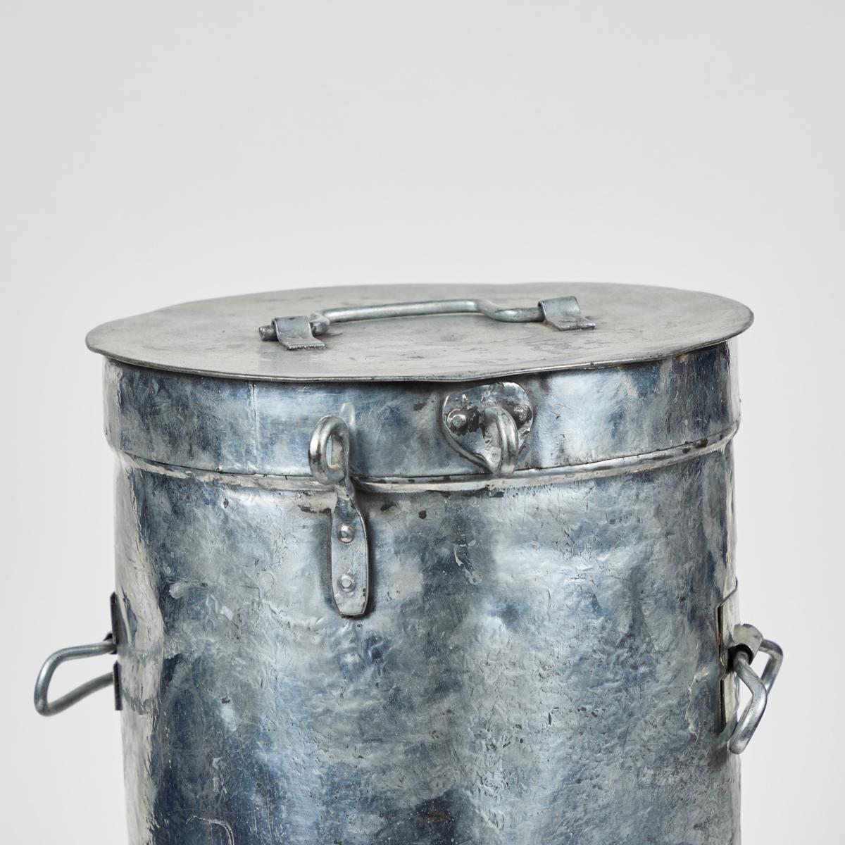 Industrial metal bin from an early 20th-century French candy factory. With its well-patinated chrome-like finish and utilitarian hardware, this piece makes a chic and ironic receptacle for waste, but may also easily be converted for use as a