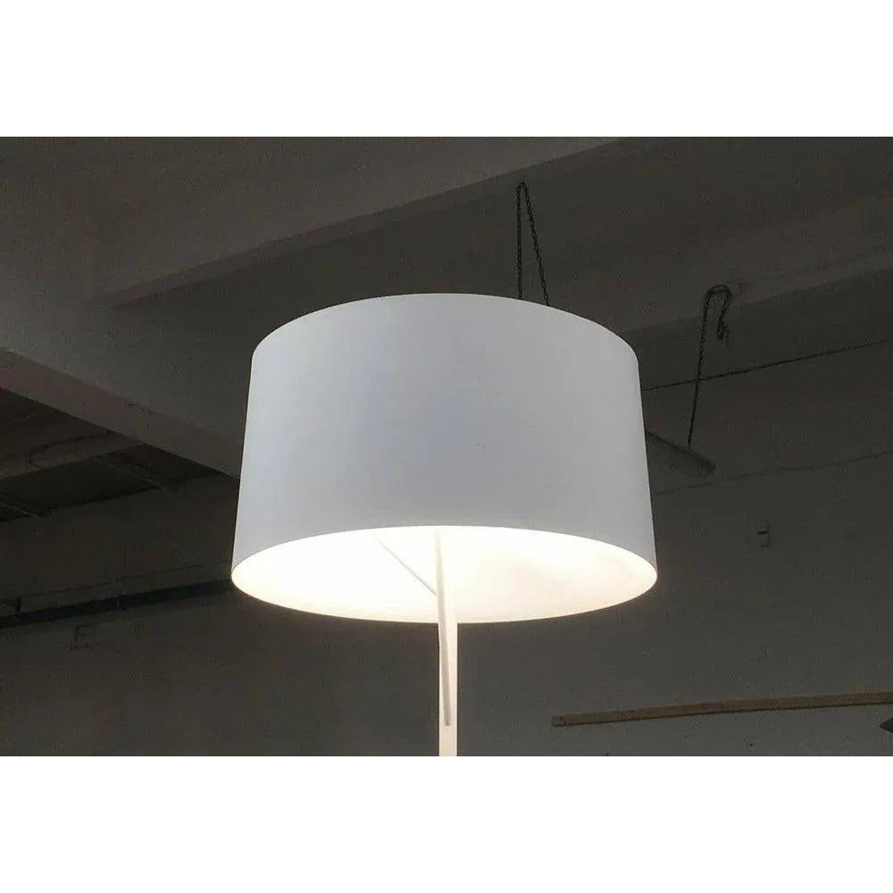 Elegant floor lamp from the Spanish manufacturer Metalarte.

The design is reminiscent of a tree. The foot as a trunk, from which two struts run like branches that hold the screen over a ring. The ring is arranged asymmetrically and open so that you