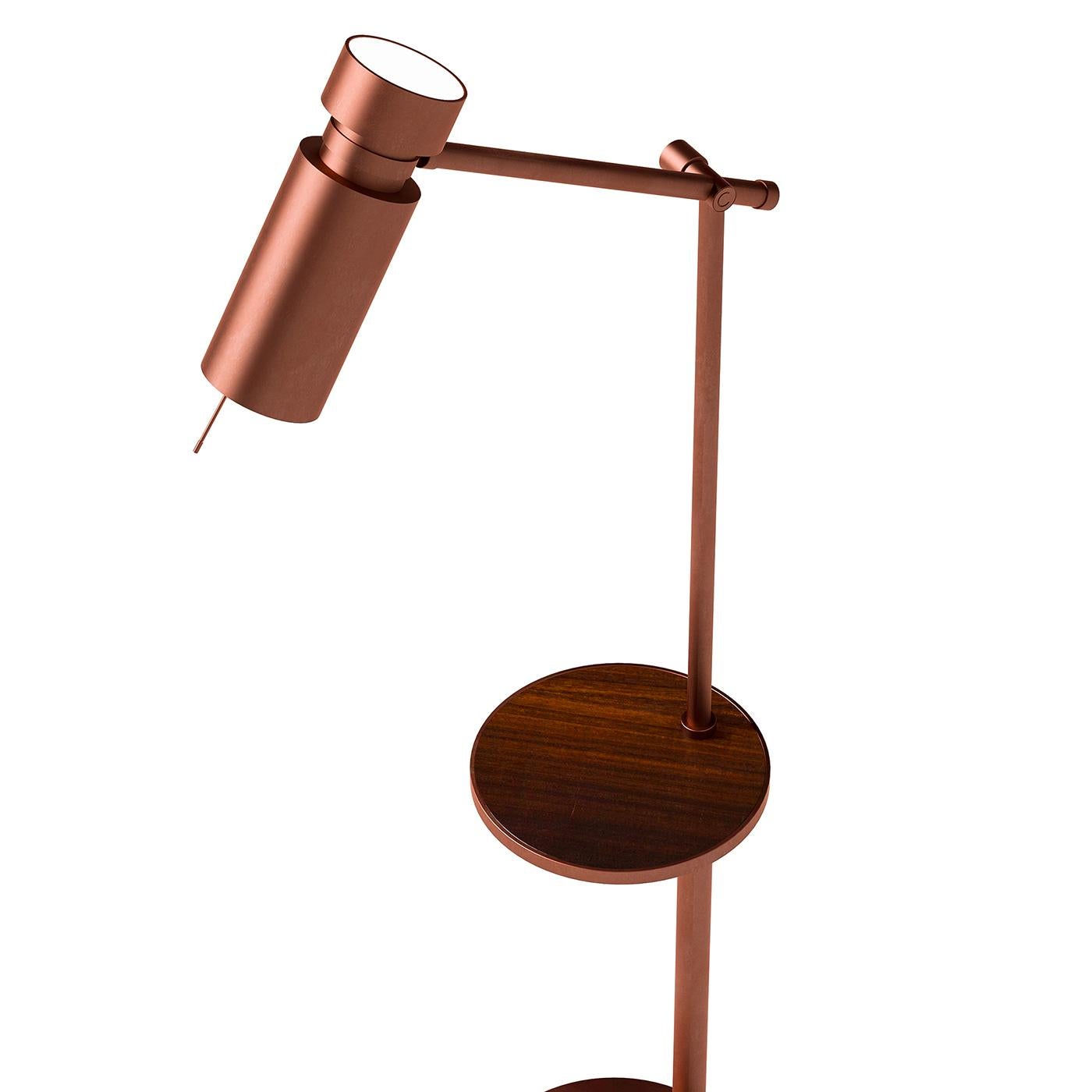 A captivating use of linear forms, this superb floor lamp will deliver Classic sophistication to any modern interior decor. Marked by a bold angular silhouette crafted of metal with a brushed-copper finish, this lamp stands on a round base and