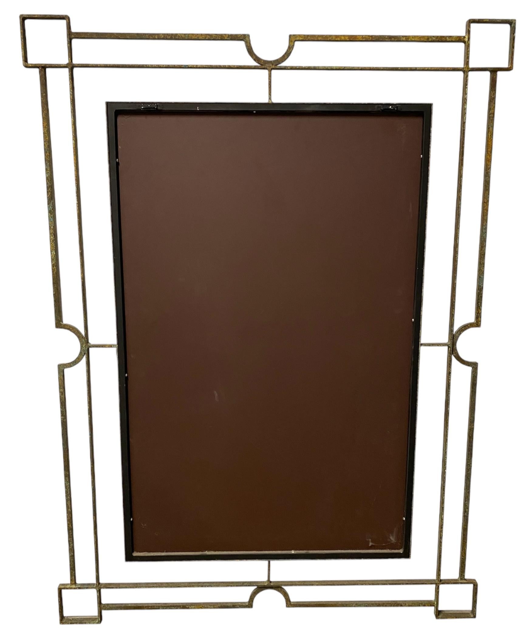 Indulge in luxury with this exquisite custom-made mirror crafted by Formations, a masterpiece no longer in production, making it a coveted collector's treasure. The metal frame, adorned with a captivating geometric motif and finished in a rich