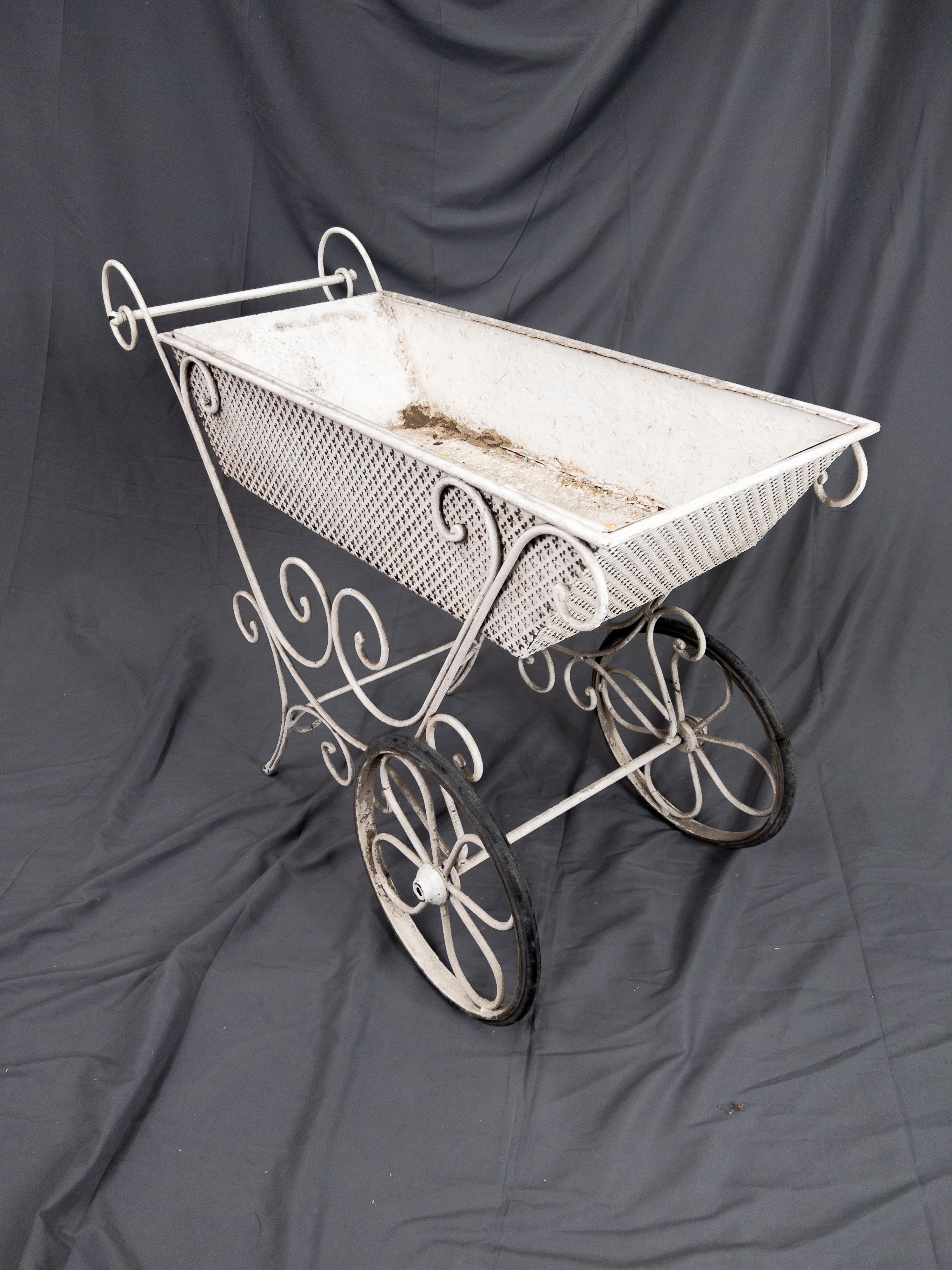 Metal French garden cart. This is a white painted metal garden cart, previously used to hold plants and other garden necessities.