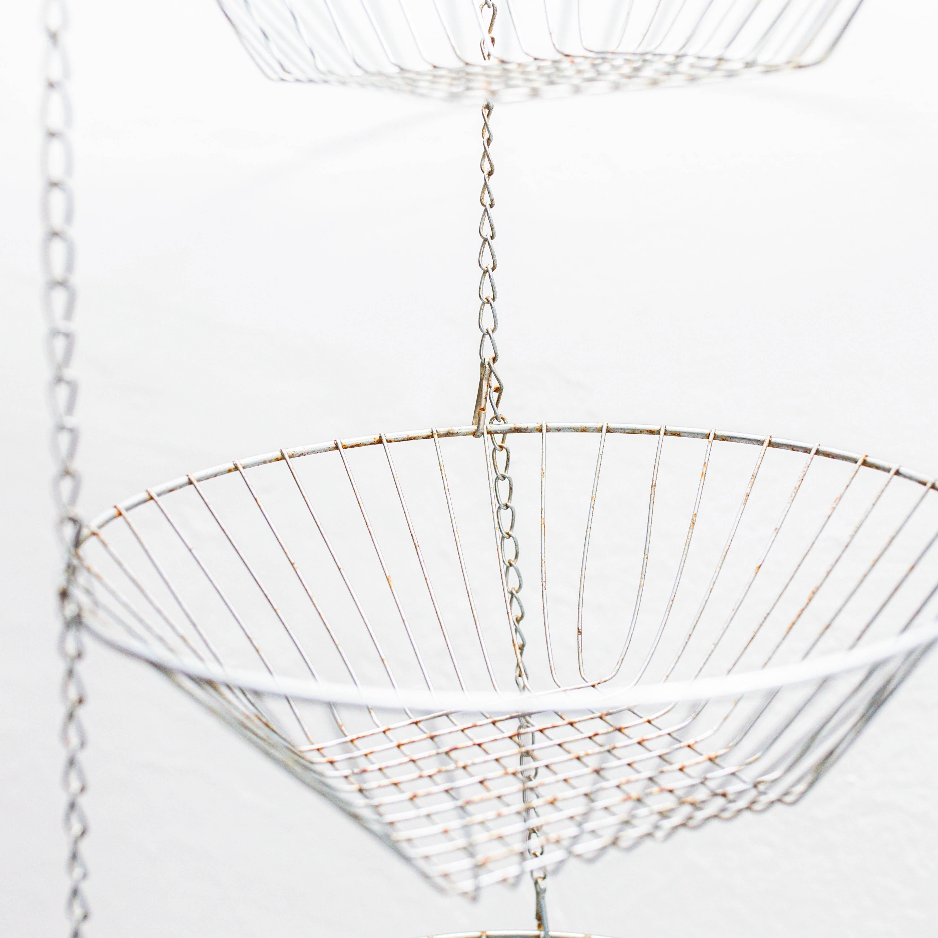 Add a touch of vintage charm to your home with this metal fruit bowl for wall hanging, featuring a unique three-tier design. Made in Spain circa 1960, the fruit bowl showcases a blend of functionality and style, making it a delightful addition to