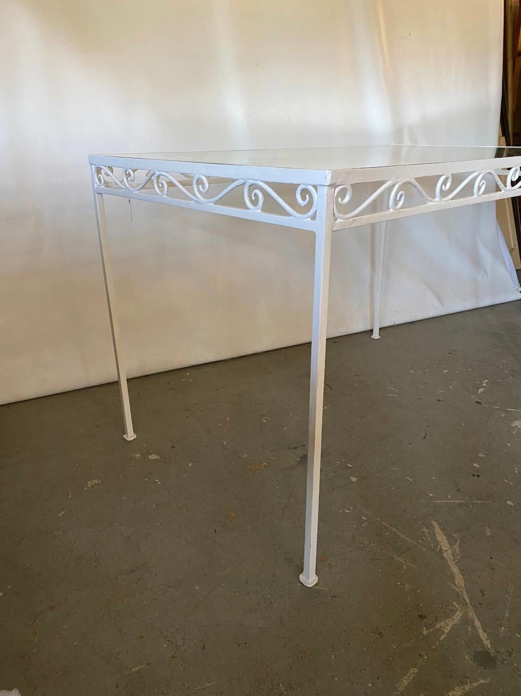 Simple and elegant handwrought dining table with original plate glass top. The wrought frame is finished with a white paint. Originally designed for outdoor or patio use, also suitable for porch or indoor use such as a kitchen table. In the style of