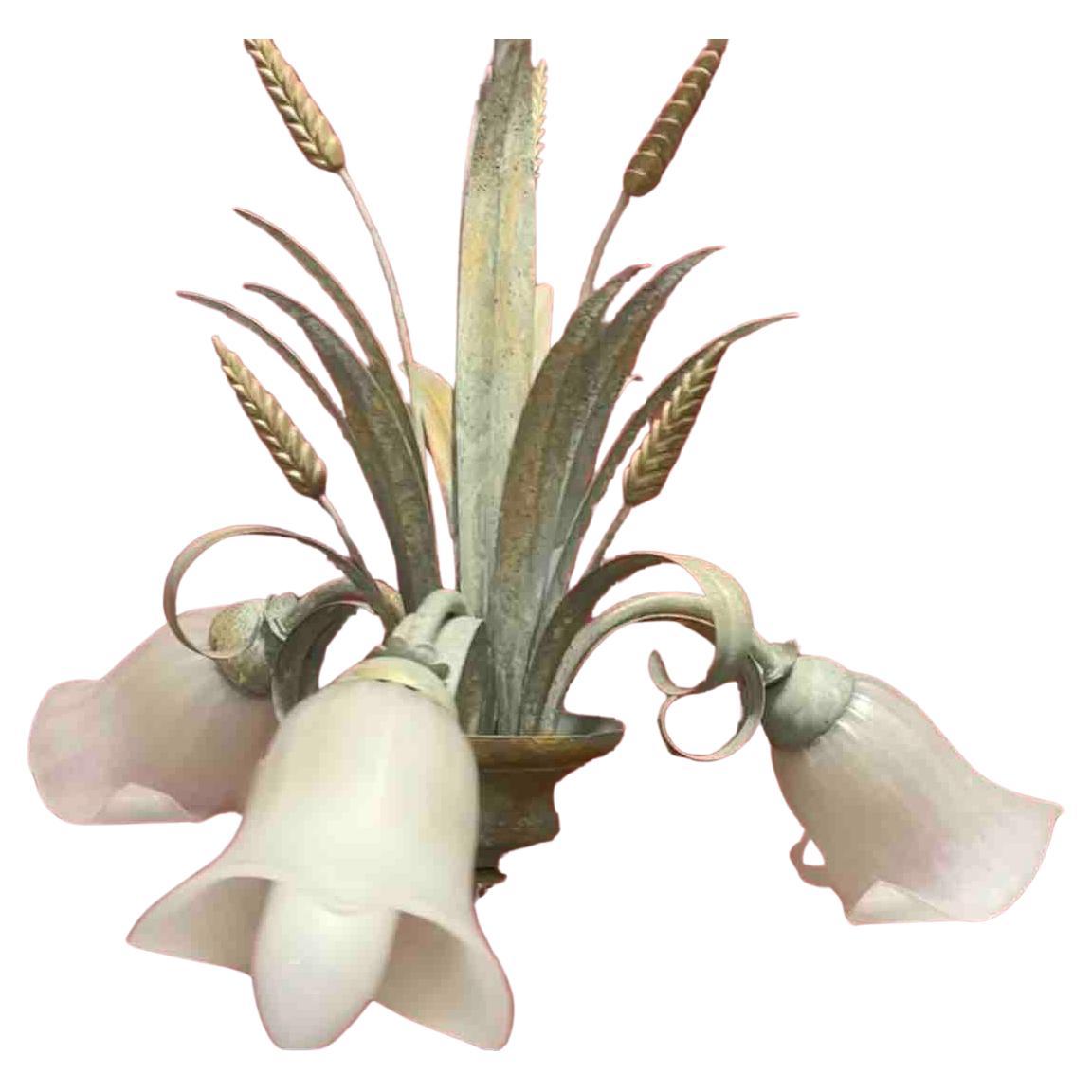 A Hollywood Regency midcentury gilt and verdigris tole wheat sheaf chandelier in Coco Chanel Style with beautiful Murano glass shades, the fixture requires three European E14 candelabra bulbs, each bulb up to 40 watts. This light has a beautiful