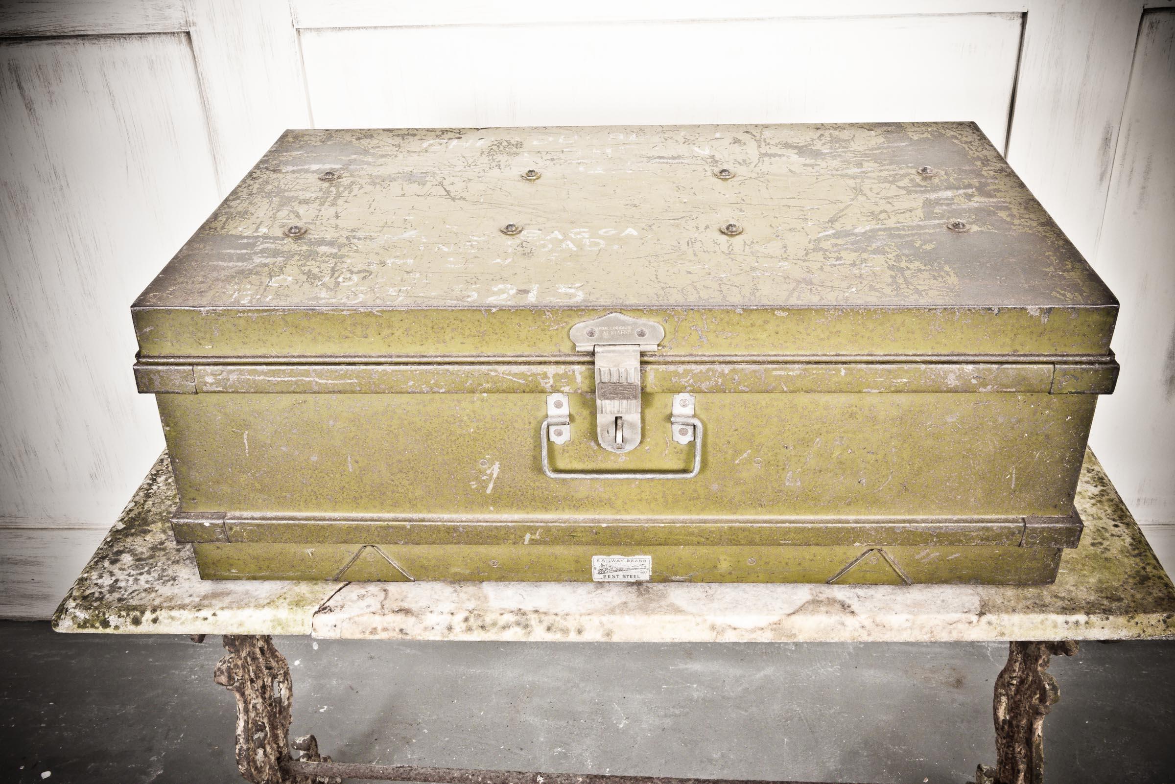 Olive green in colour, this metal travel box originating in India from the thirties has a studded top with two small handles either side for ease of transportation. The box also has two company stickers 