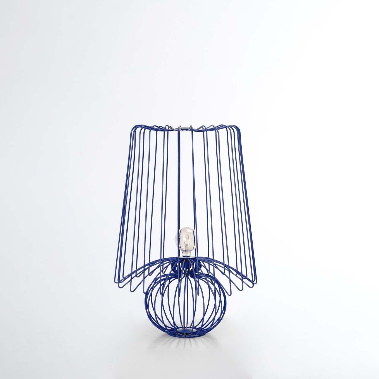 Achieving perfect harmony between light and transparency, this handmade wired piece can be used either for lighting or as a contemporary decorative item and statement lamp. With its distinctive design derived from rounded wire shapes and an imposing