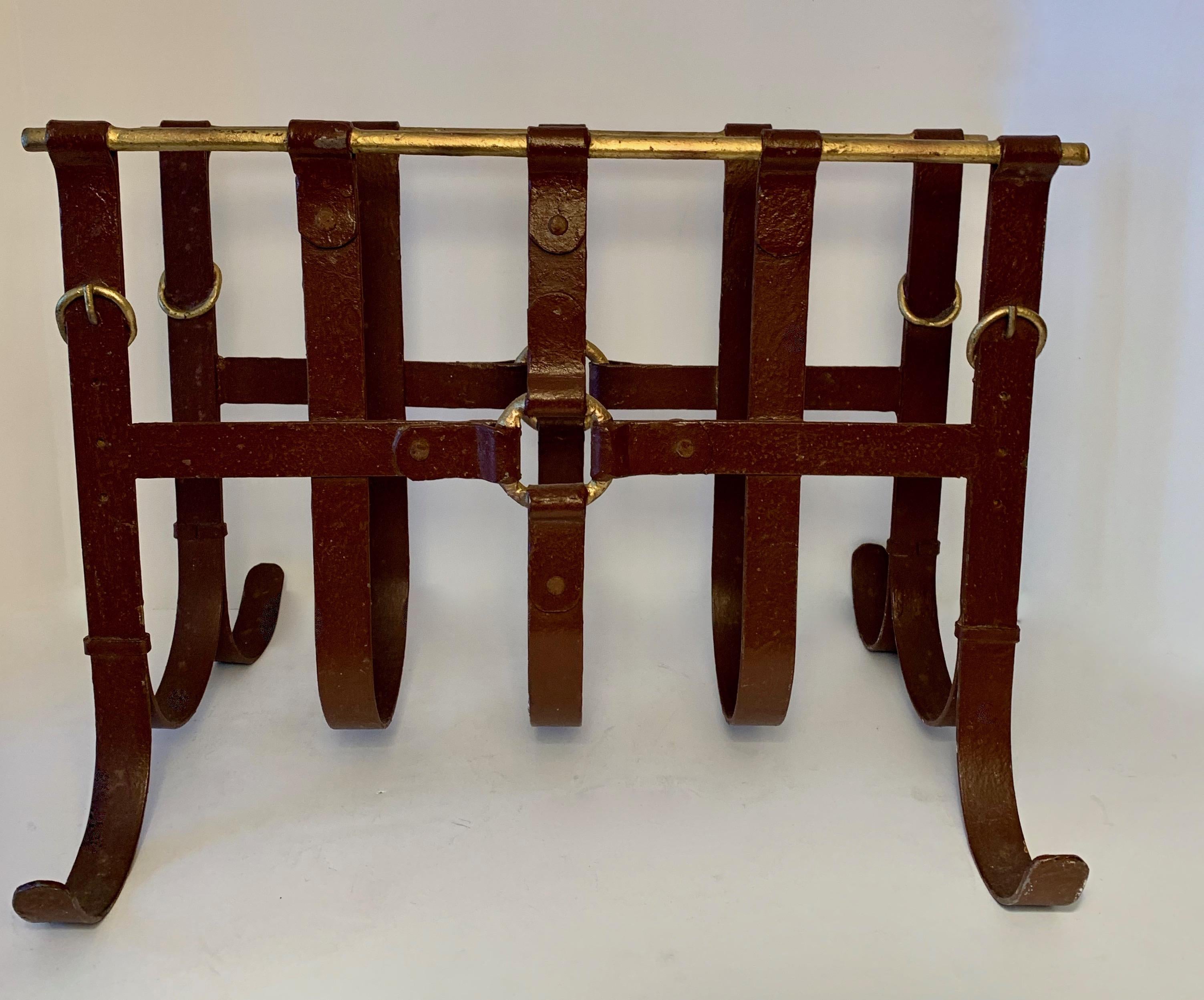 Iron magazine rack made of iron, painted to have a faux leather look and fitted with details reminiscent of gilt belt hardware - The look is reminiscent of Jacques Adnet.