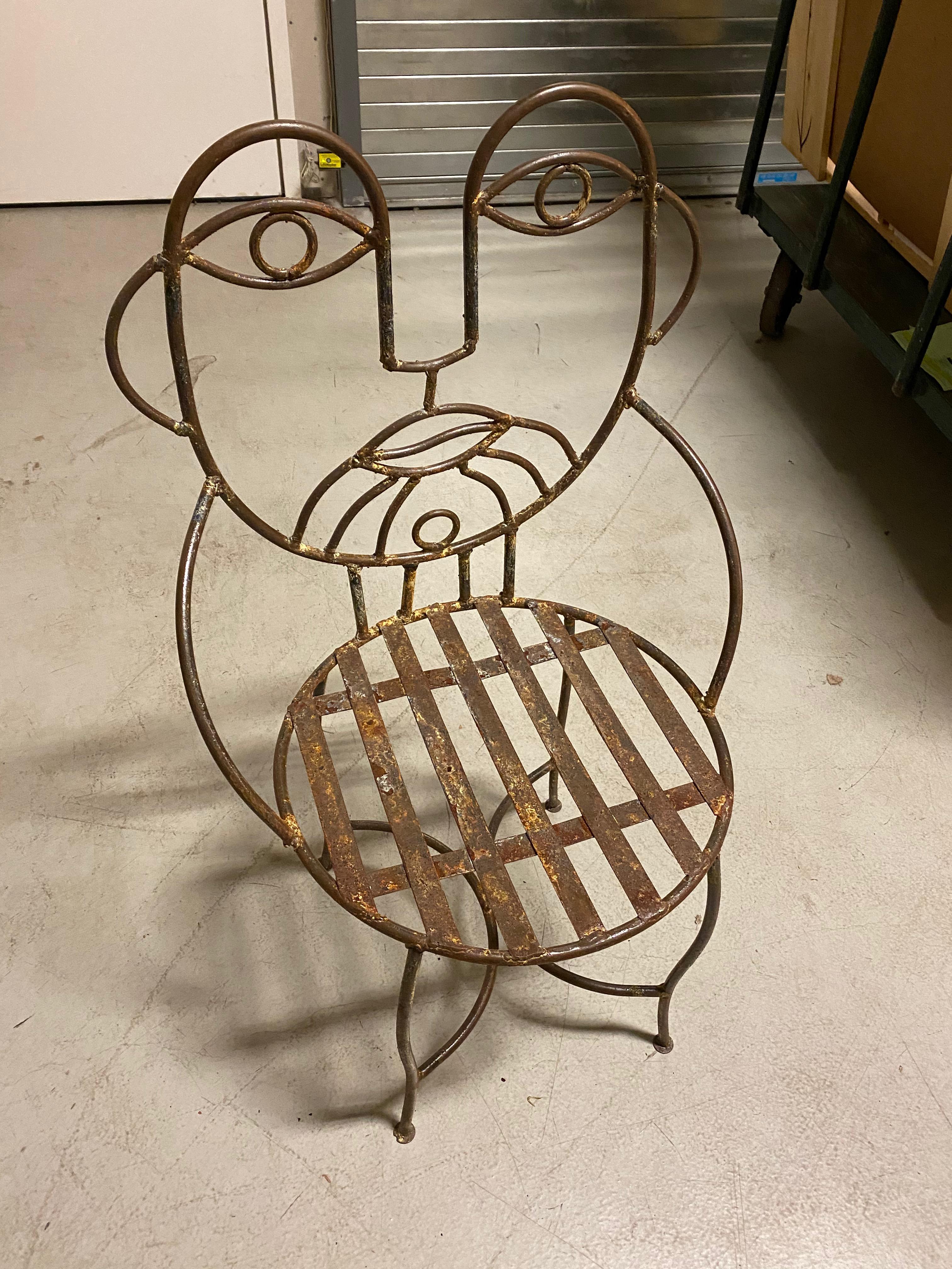 Set of two Mid-Century Modern cafe chairs with male and female faces on setbacks. One female, One male. Sold as is.