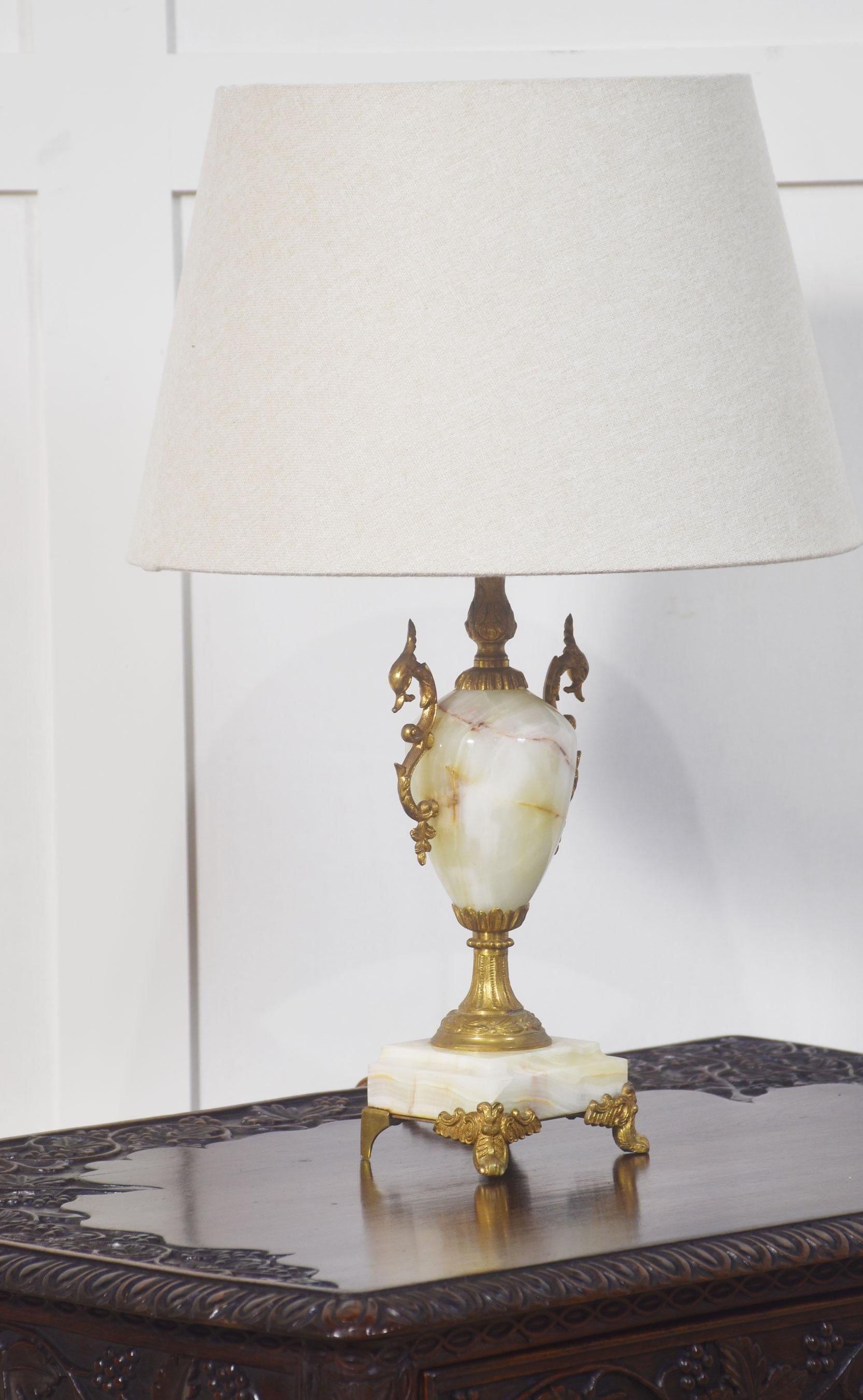 Green onyx table lamp, of urn shape having gilt metal mounts on square stepped bases raised on scrolling feet.
Dimensions
Height 14 Inches
Width 5 Inches
Depth 4 Inches