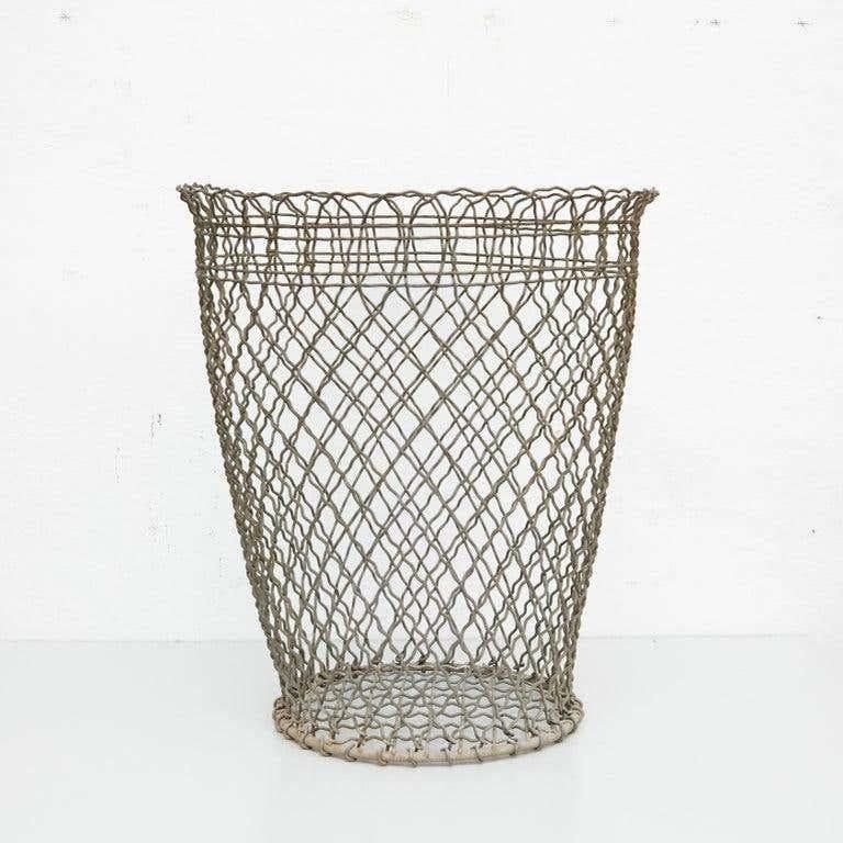 Metal paper bin made by wire woven in a Classic cross-hatched pattern completed by a solid ring.  Unknown manufacturer, France, circa 1940  Materials: metal  Dimensions:  diameter 40 x 45 height cm  In original condition, with minor wear consistent