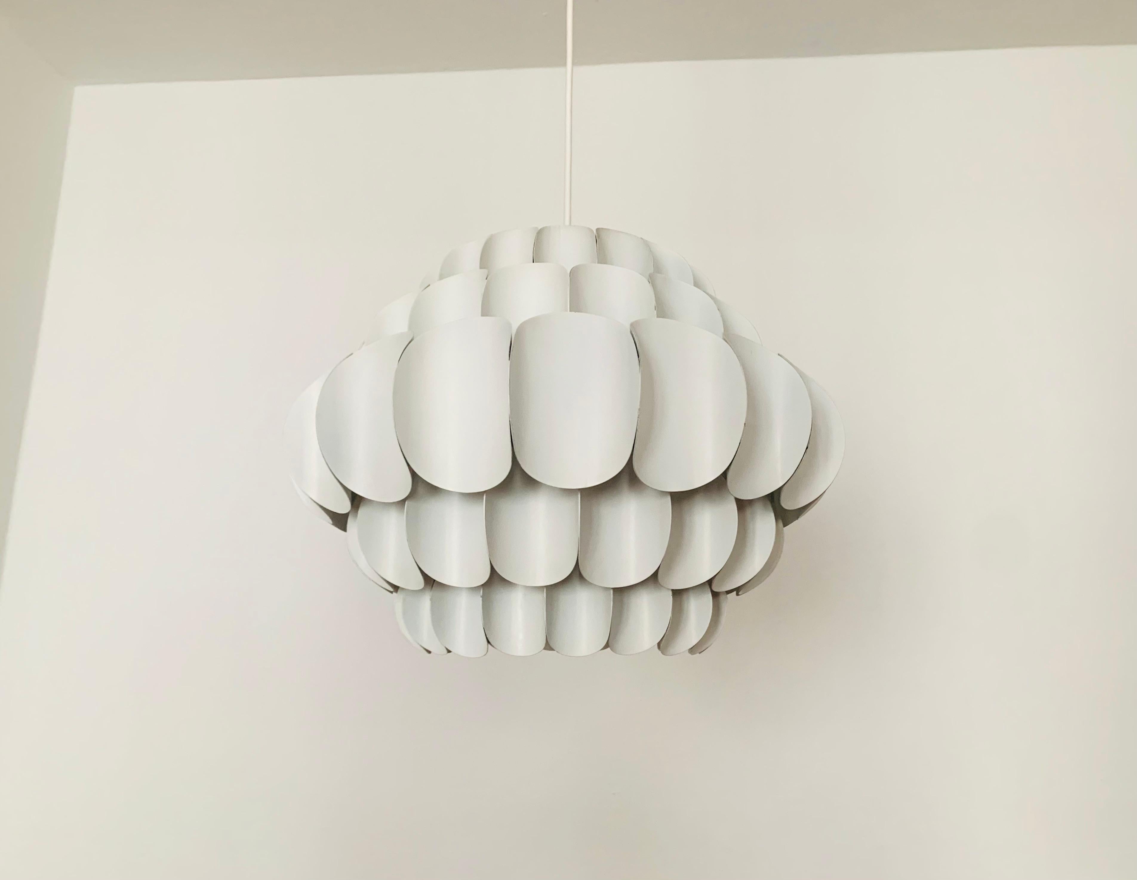 Wonderful white metal pendant lamp by Thorsten Orrling from the 1960s.
The extraordinary design creates a fantastic play of light in the room.
Large version with 5 rows.

Condition:

Very good vintage condition with slight signs of wear consistent
