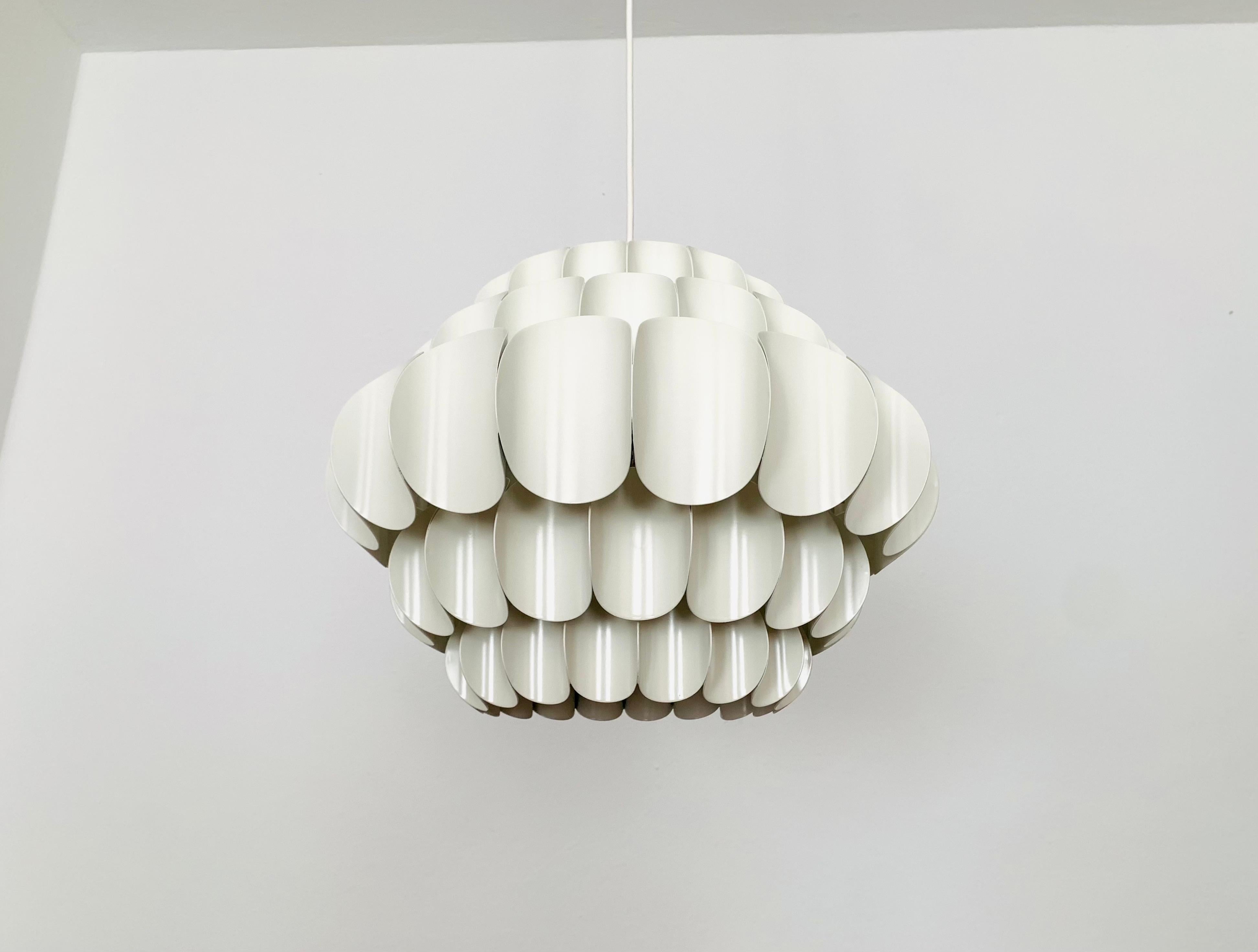 Wonderful white metal pendant lamp by Thorsten Orrling from the 1960s.
The extraordinary design creates a fantastic play of light in the room.
Large version with 5 rows.

Condition:

Very good vintage condition with slight signs of wear consistent