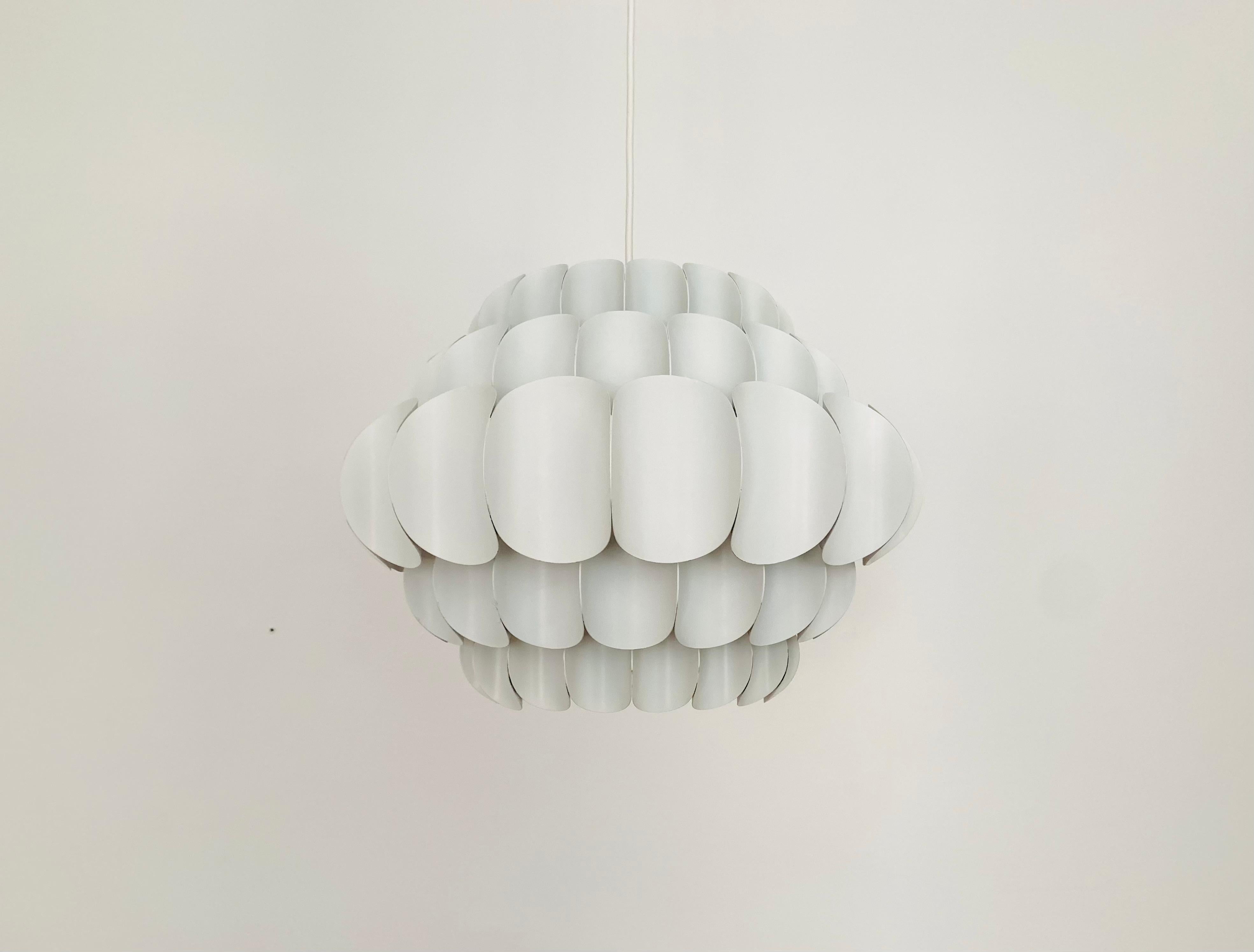 Wonderful white metal pendant lamp by Thorsten Orrling from the 1960s.
The unusual design creates a fantastic play of light in the room.
Large version with 5 rows.

Condition:

Very good vintage condition with slight signs of age-related