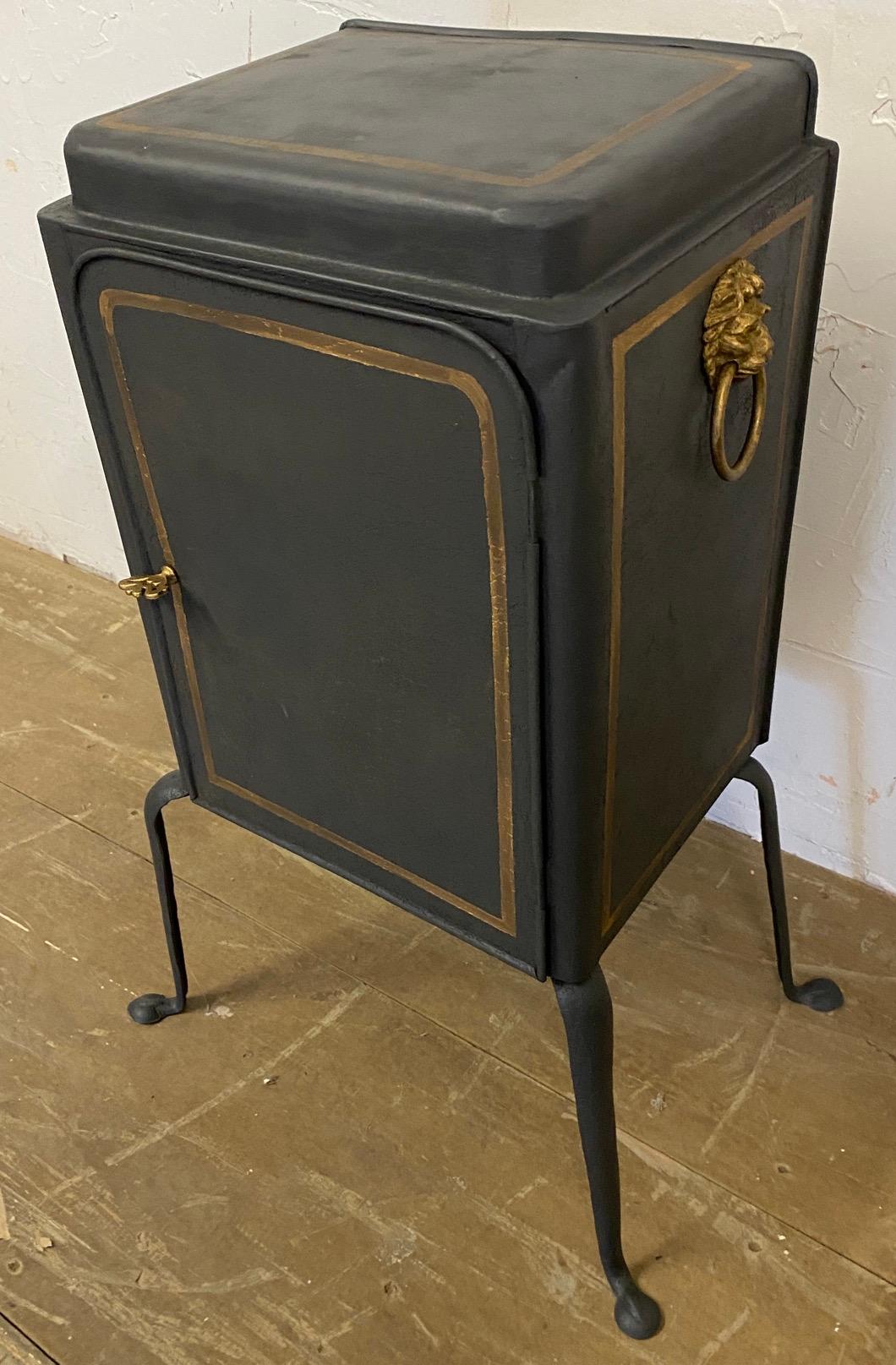 Unusual antique pie safe that has been made into a nightstand. A back has been added to what once was open for the pies to cool after it has been taken out of the oven. This particular stand is especially elegant with the gold trim and lion head