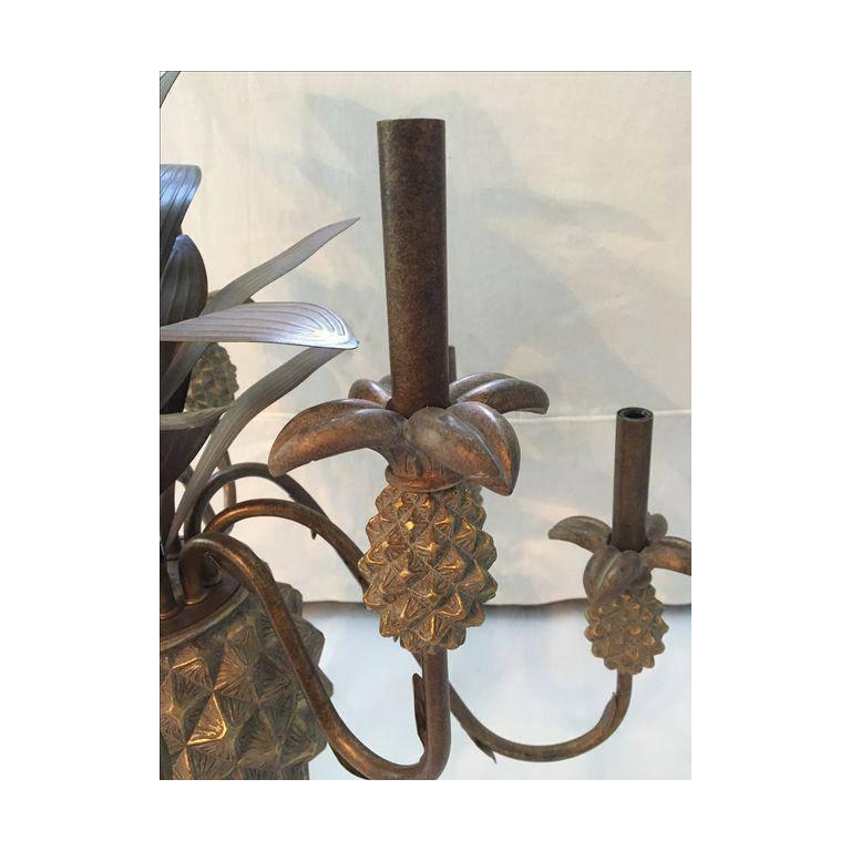 Tropical nine-arm pineapple chandelier features metal leaves and accents and composite body. Very good vintage condition with minor imperfections consistent with age.

Dimensions: 29.0