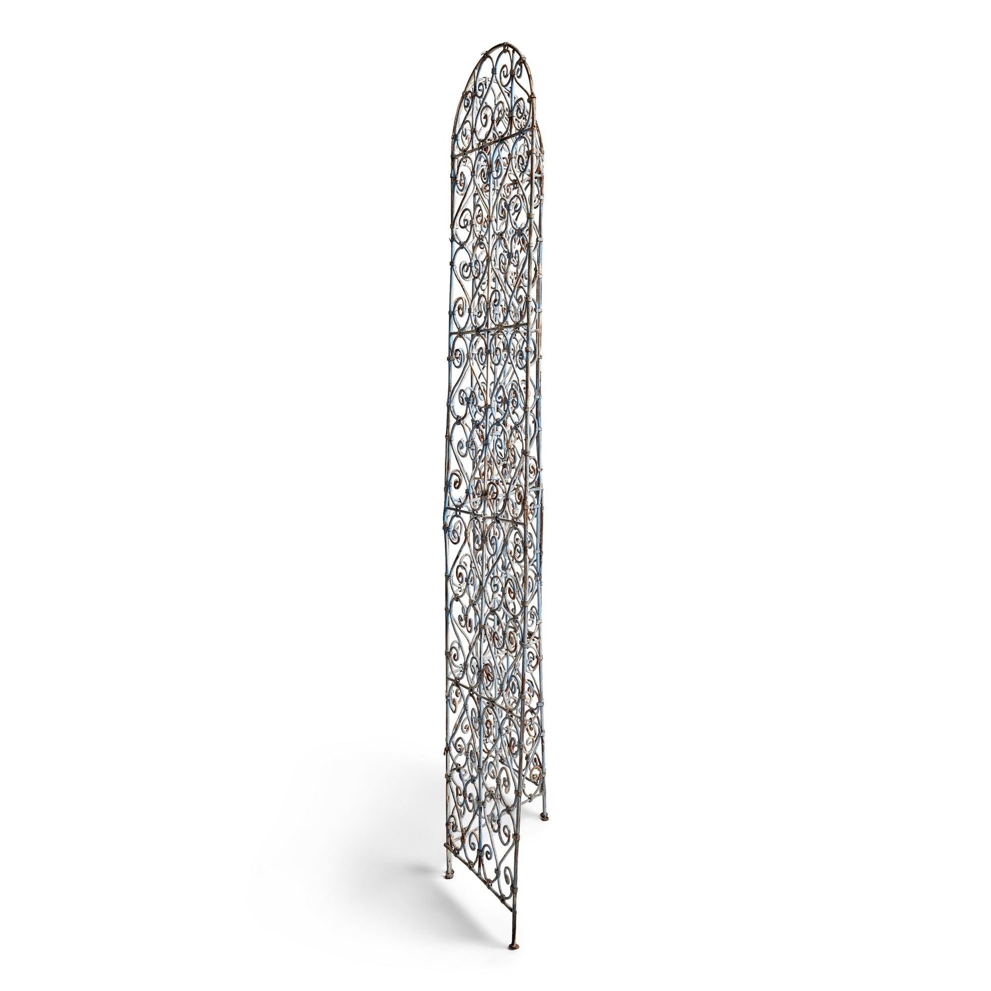 A rustic metal screen/room divider made from weathered, bent metal, exuding an aged and authentically weathered aesthetic.