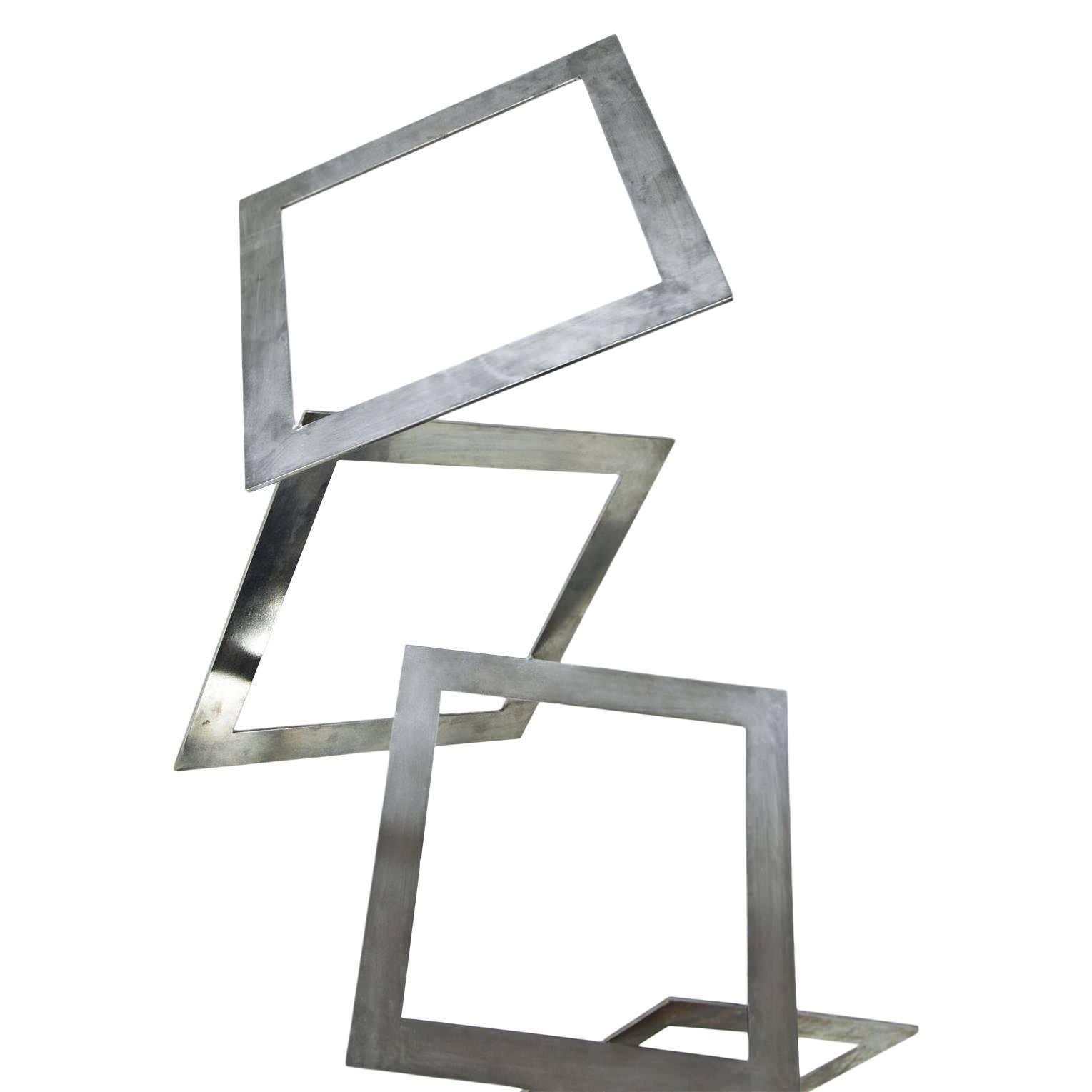 Metal sculpture by Ernesto Riva (born 1913) consisting of several metal squares which are welded together. The artist had not the construction itself in mind, but furthermore the effect it has on its surroundings. Positive and negative volumes