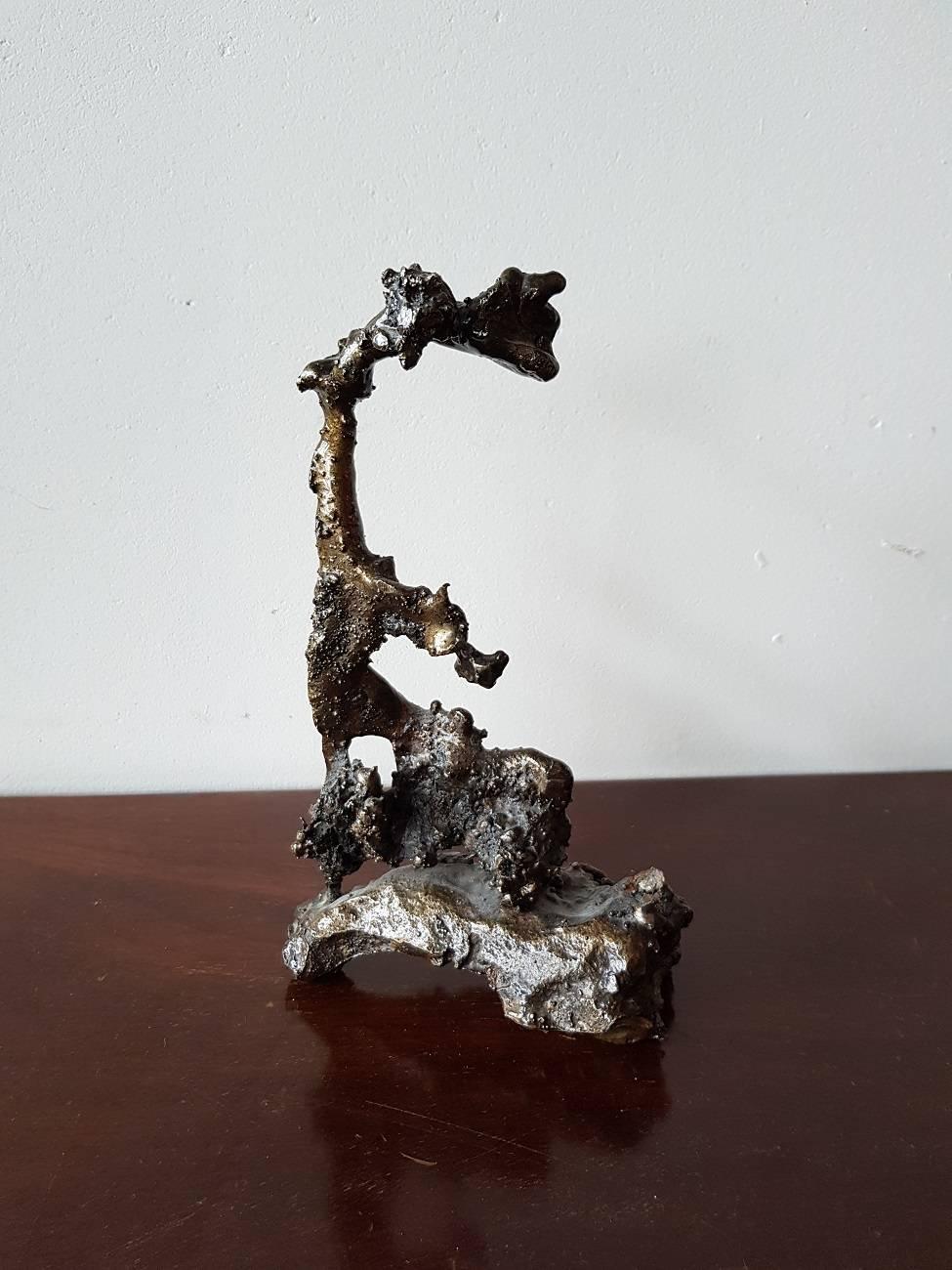 Beautiful Metal sculpture in a rough cast form and in every perspective you can see several things or persons, 20th century.

The measurements are,
Depth 7 cm/ 2.7 inch.
Width 12.5 cm/ 4.9 inch.
Height 21 cm/ 8.2 inch.
  