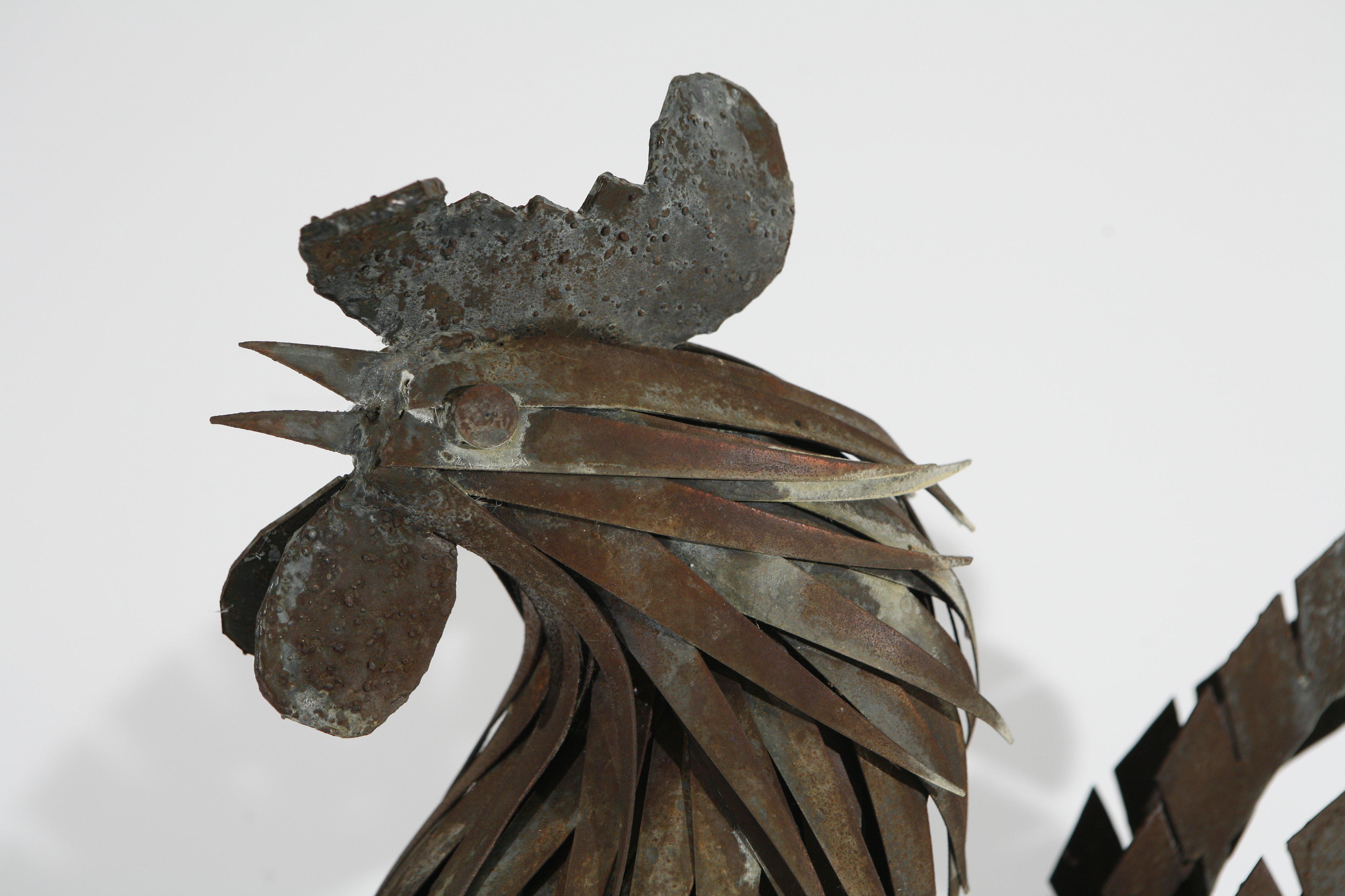 Metal sculpture of a rooster.